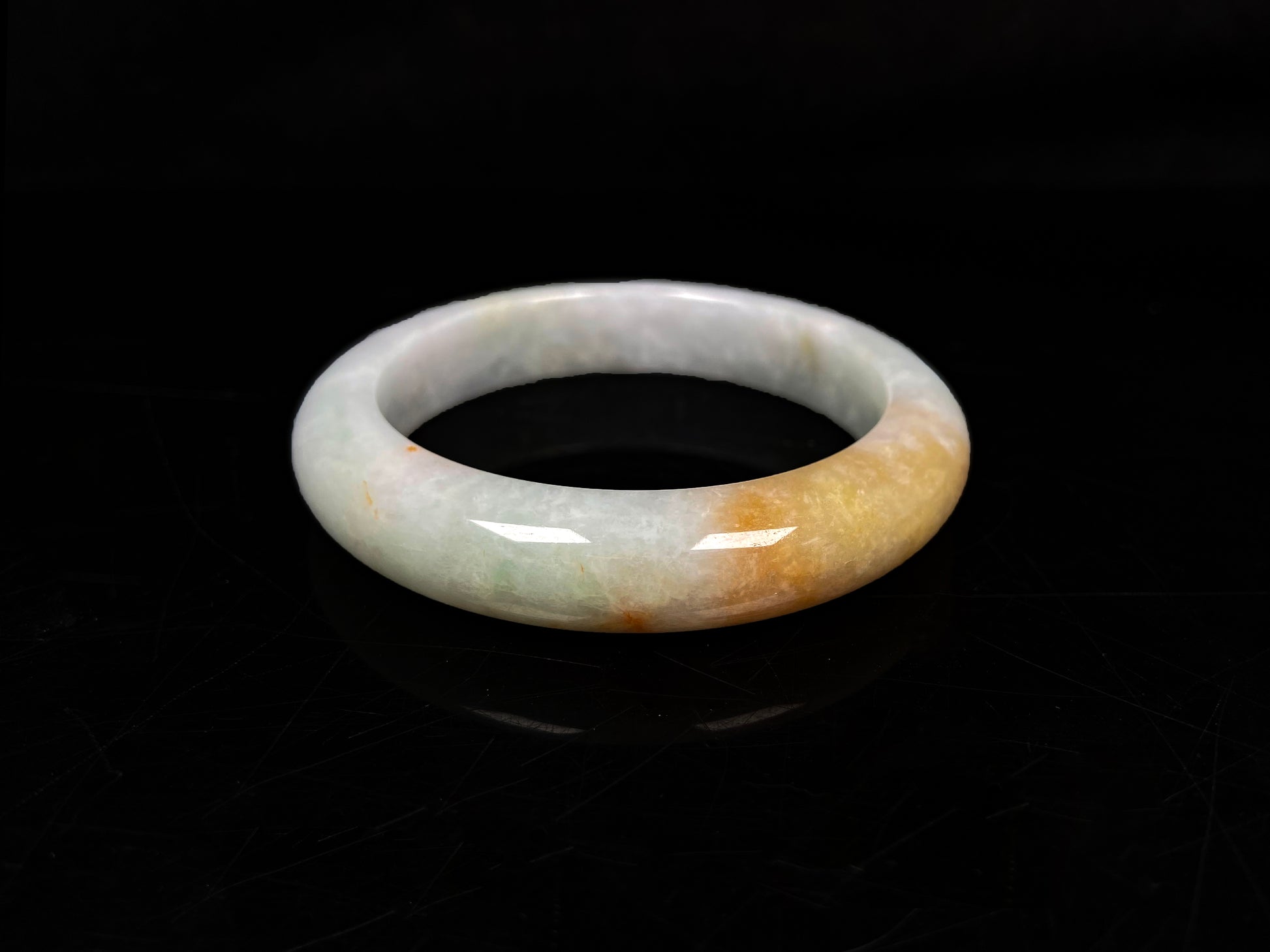 A light fernery gilded mist jadeite bangle.