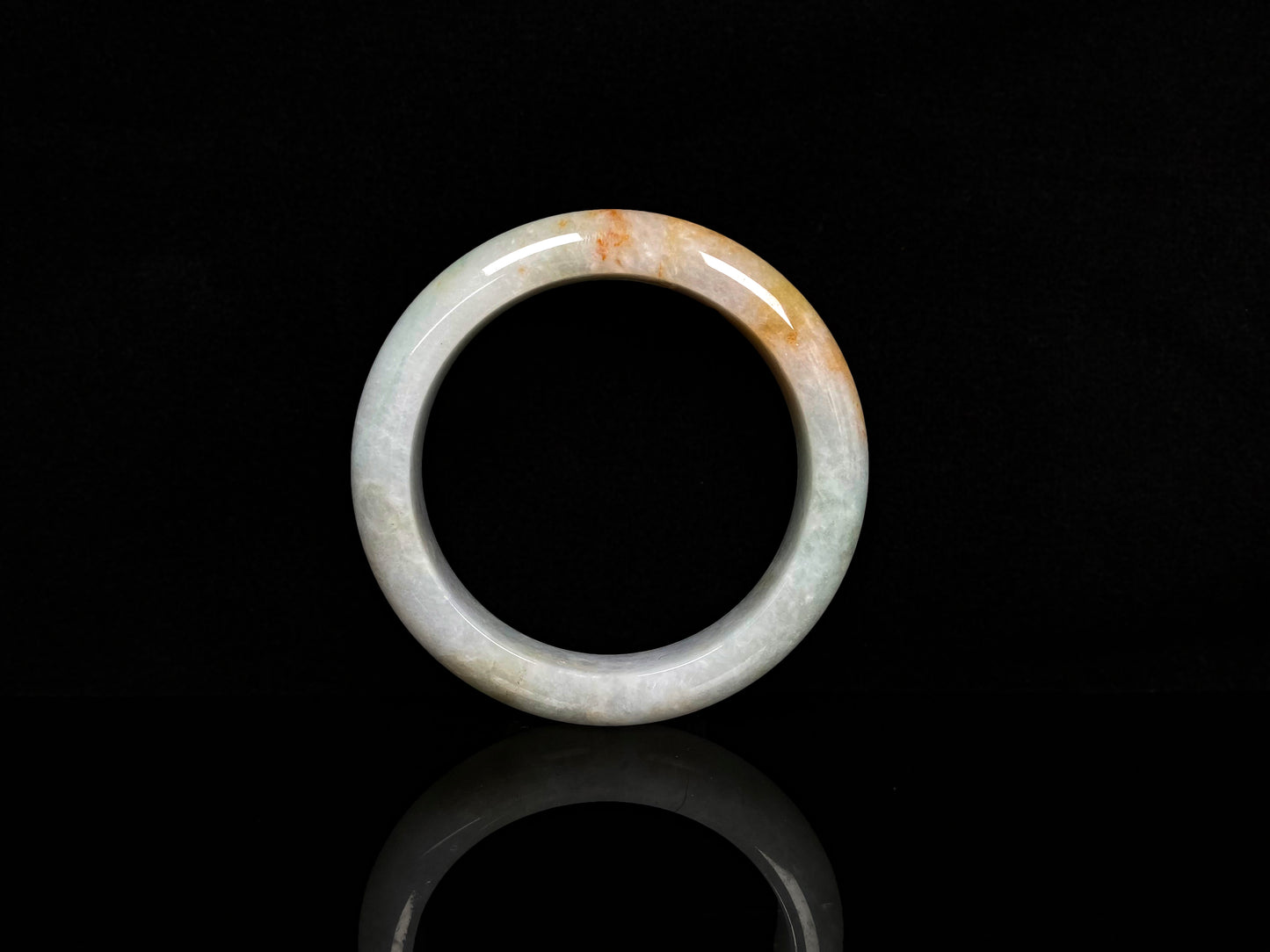 A light fernery gilded mist jadeite bangle.