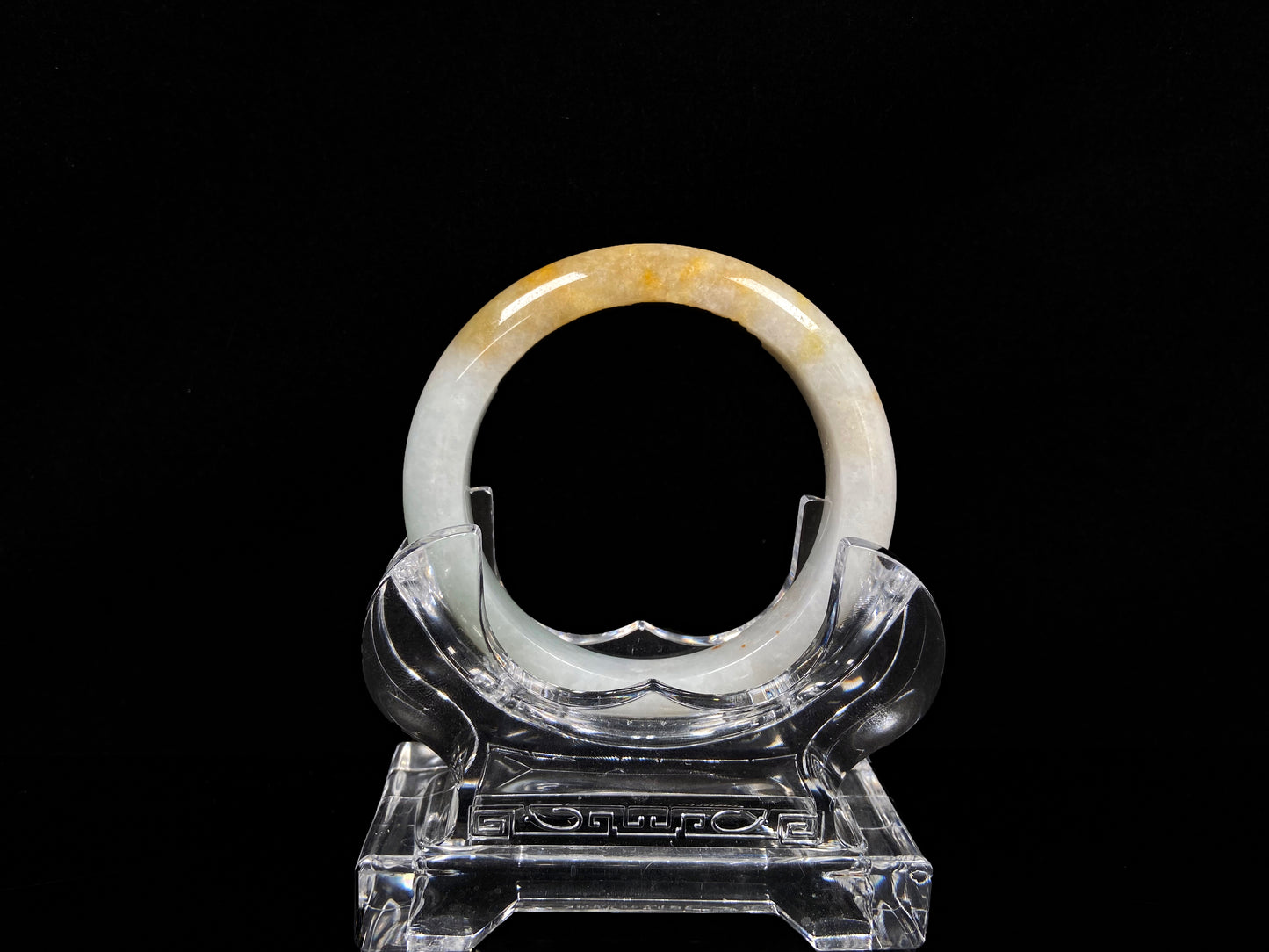 A creamy white with green and honey yellow  jadeite bangle.