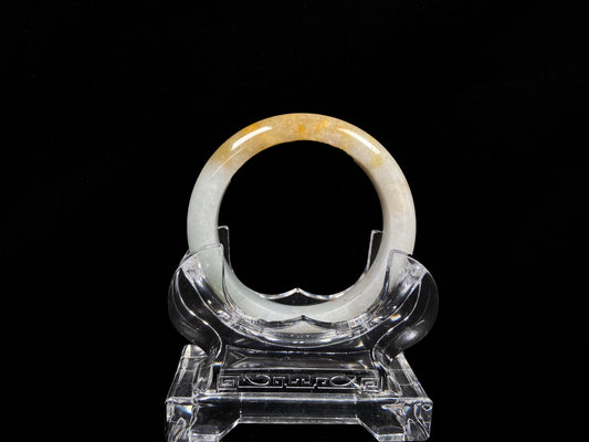 A creamy white with green and honey yellow  jadeite bangle.