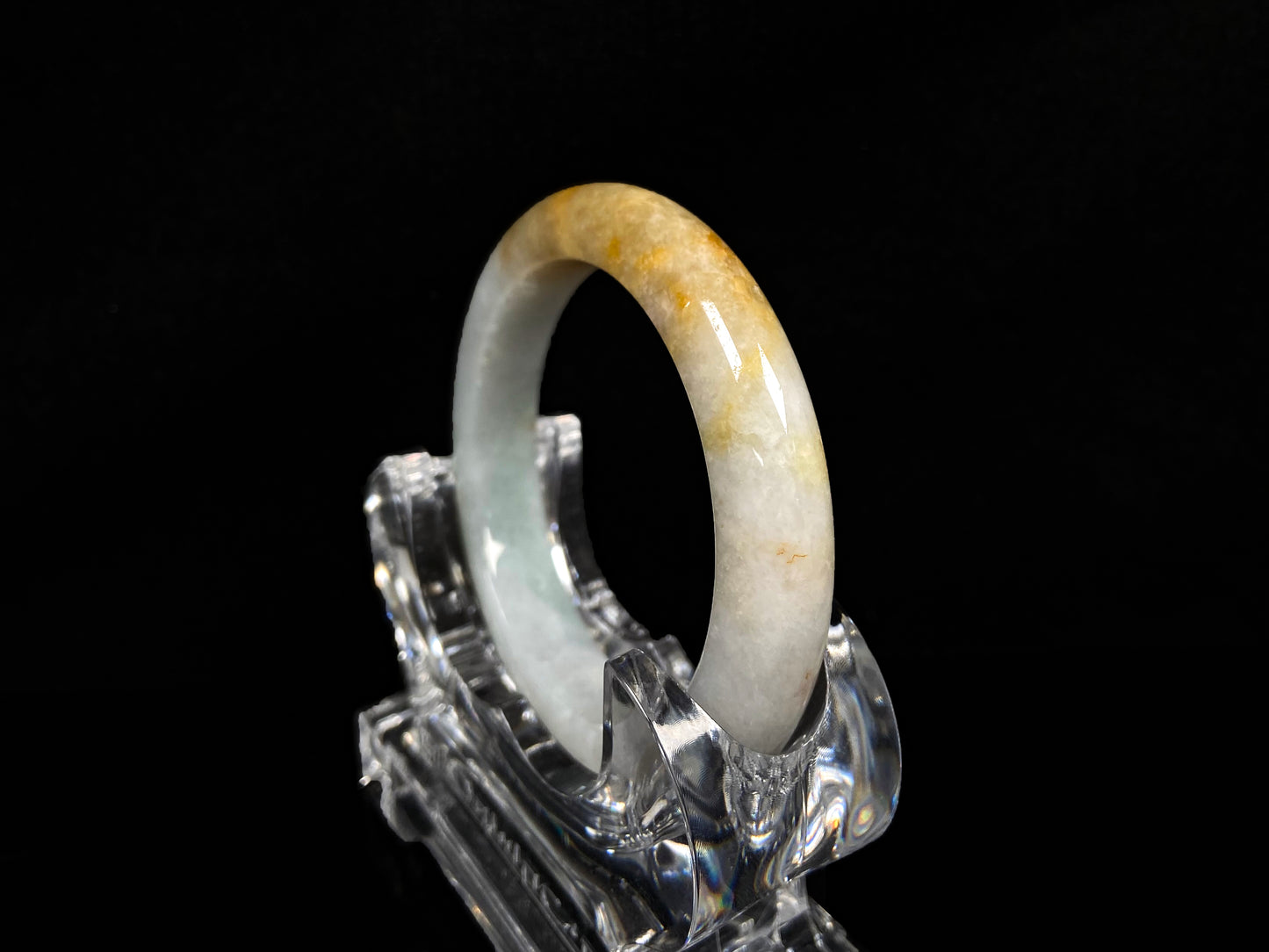 A creamy white with green and honey yellow  jadeite bangle.