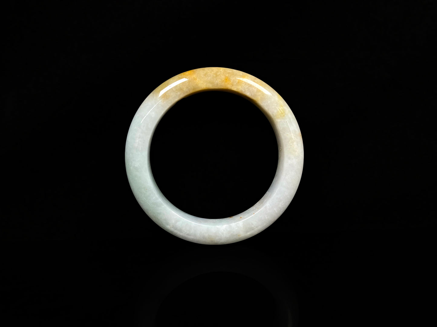 A creamy white with green and honey yellow  jadeite bangle.