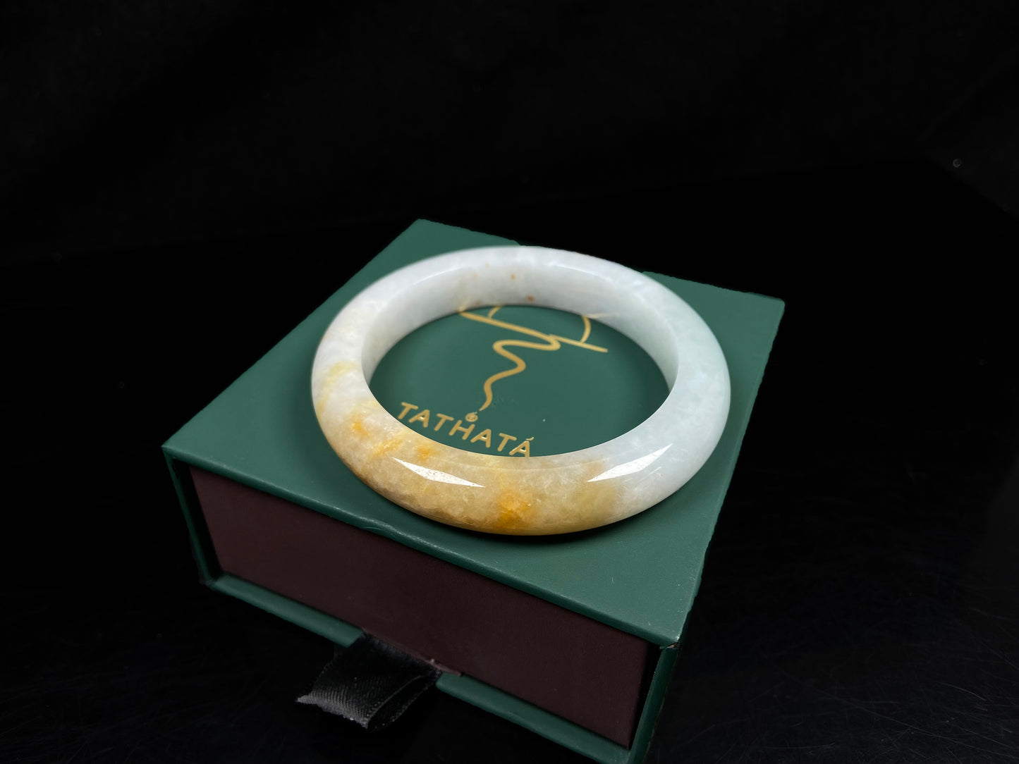 A creamy white with green and honey yellow  jadeite bangle.