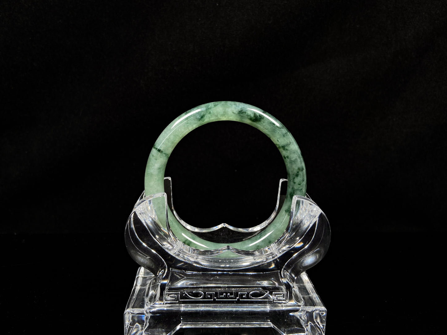 A waxy icy with moss green jadeite bangle.