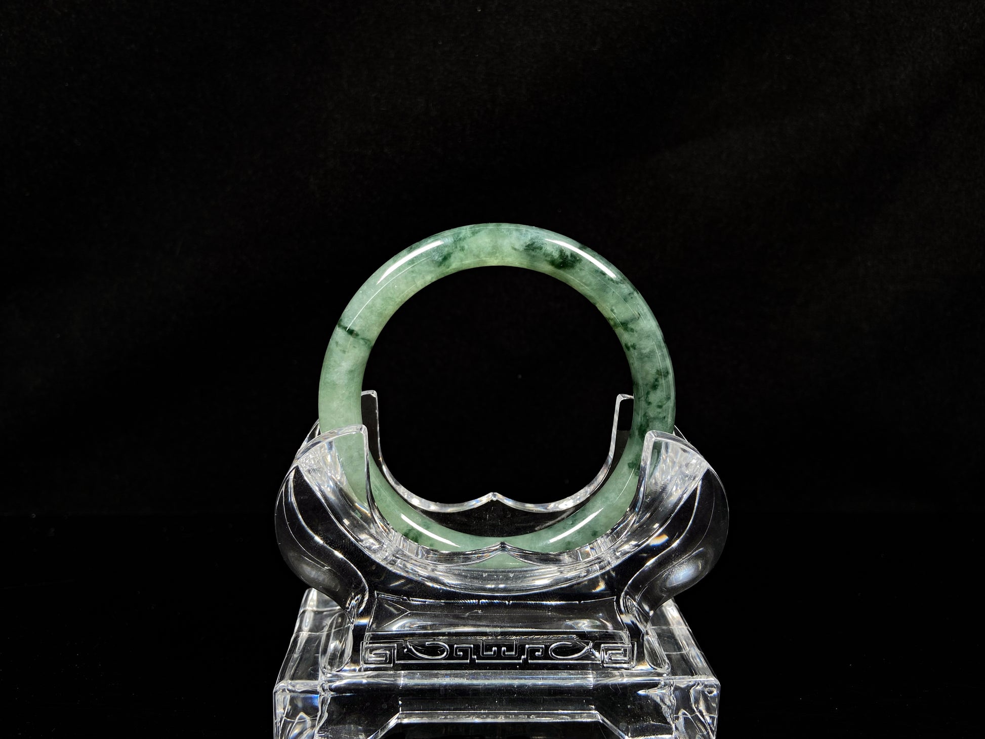 A waxy icy with moss green jadeite bangle.