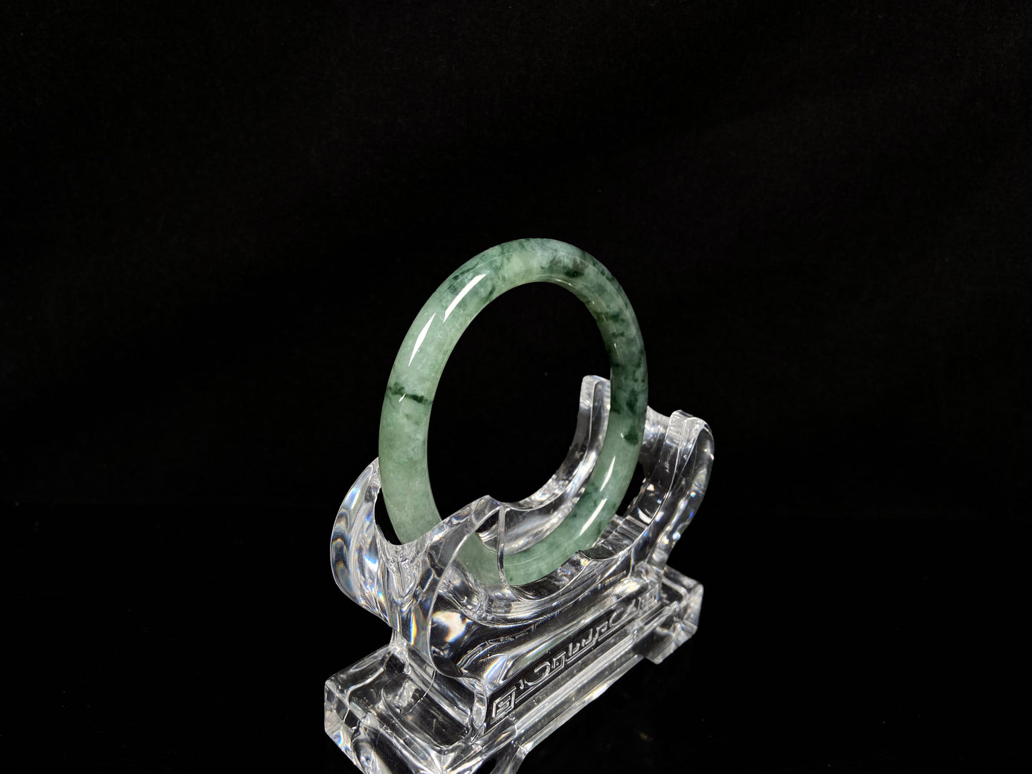 A waxy icy with moss green jadeite bangle.