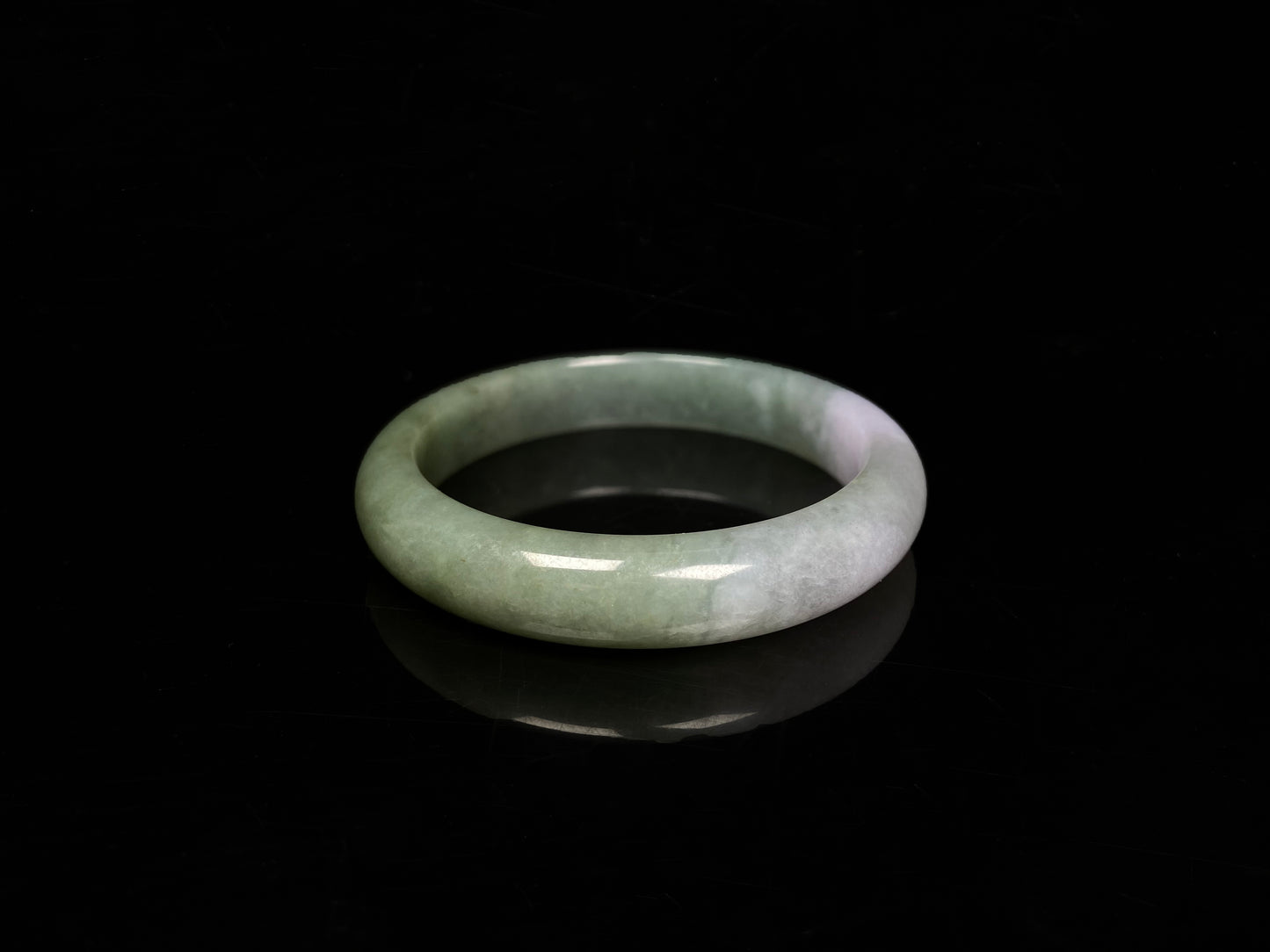 A misty sage base with wispy frosted white veins jadeite bangle.