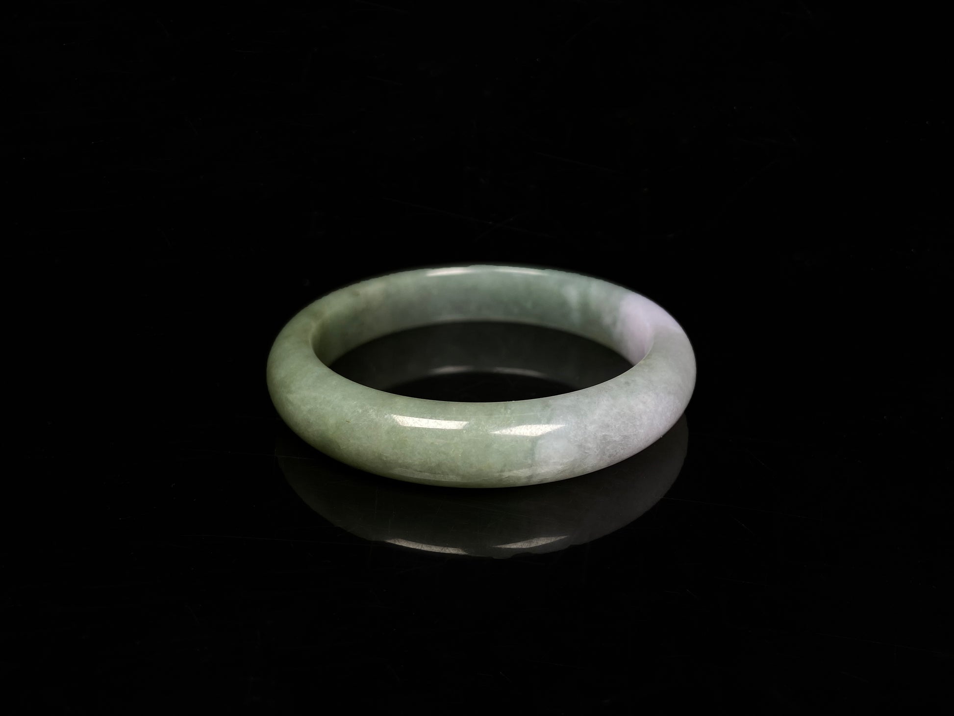 A misty sage base with wispy frosted white veins jadeite bangle.