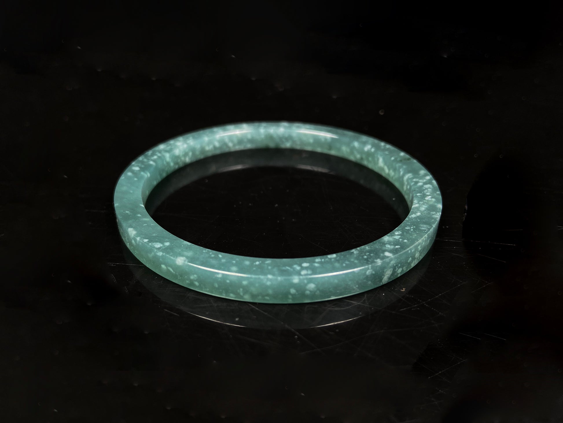 A frosted cyan sparkle jadeite bangle.