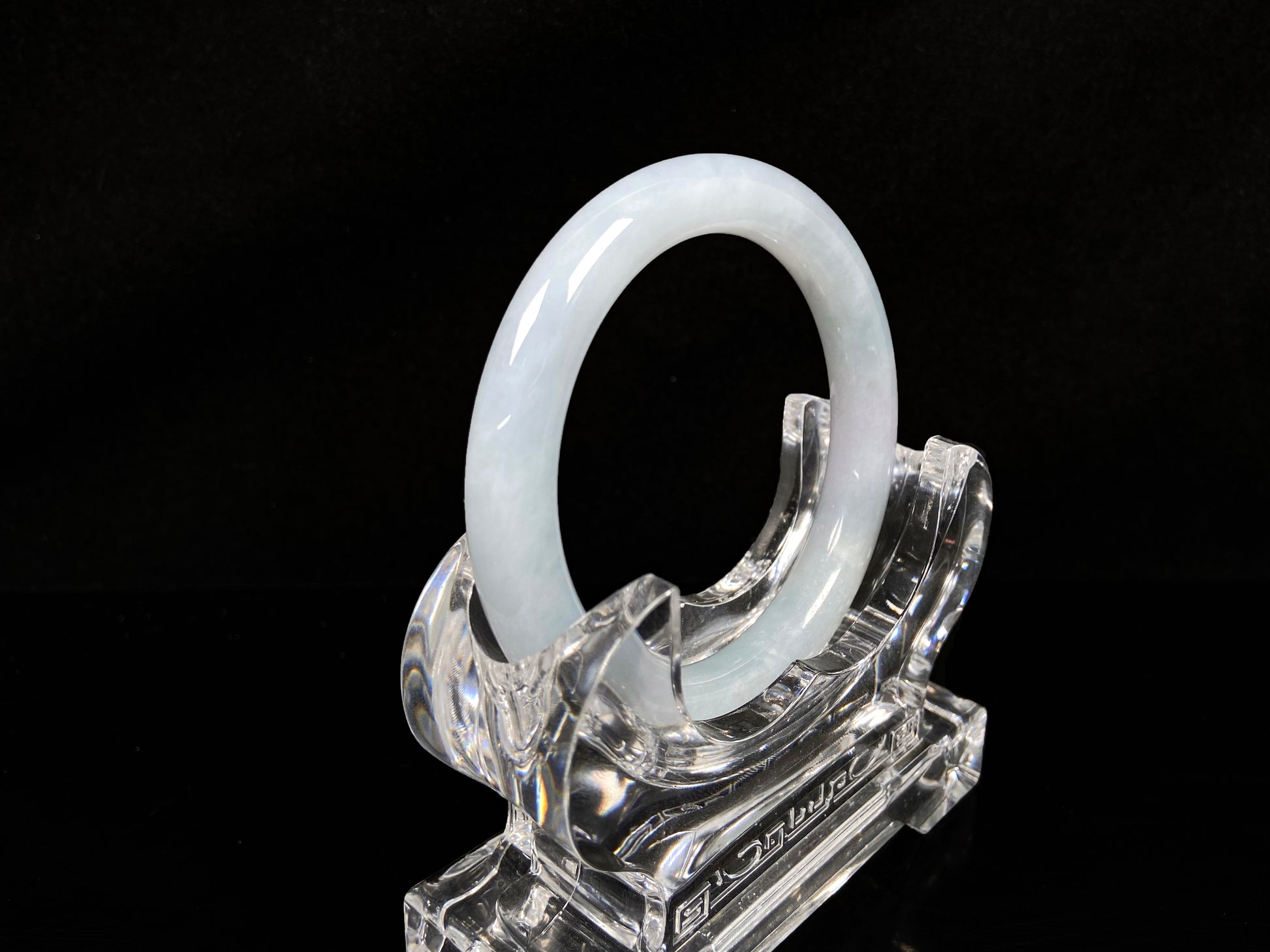 A lunar white blue green jadeite bangle.