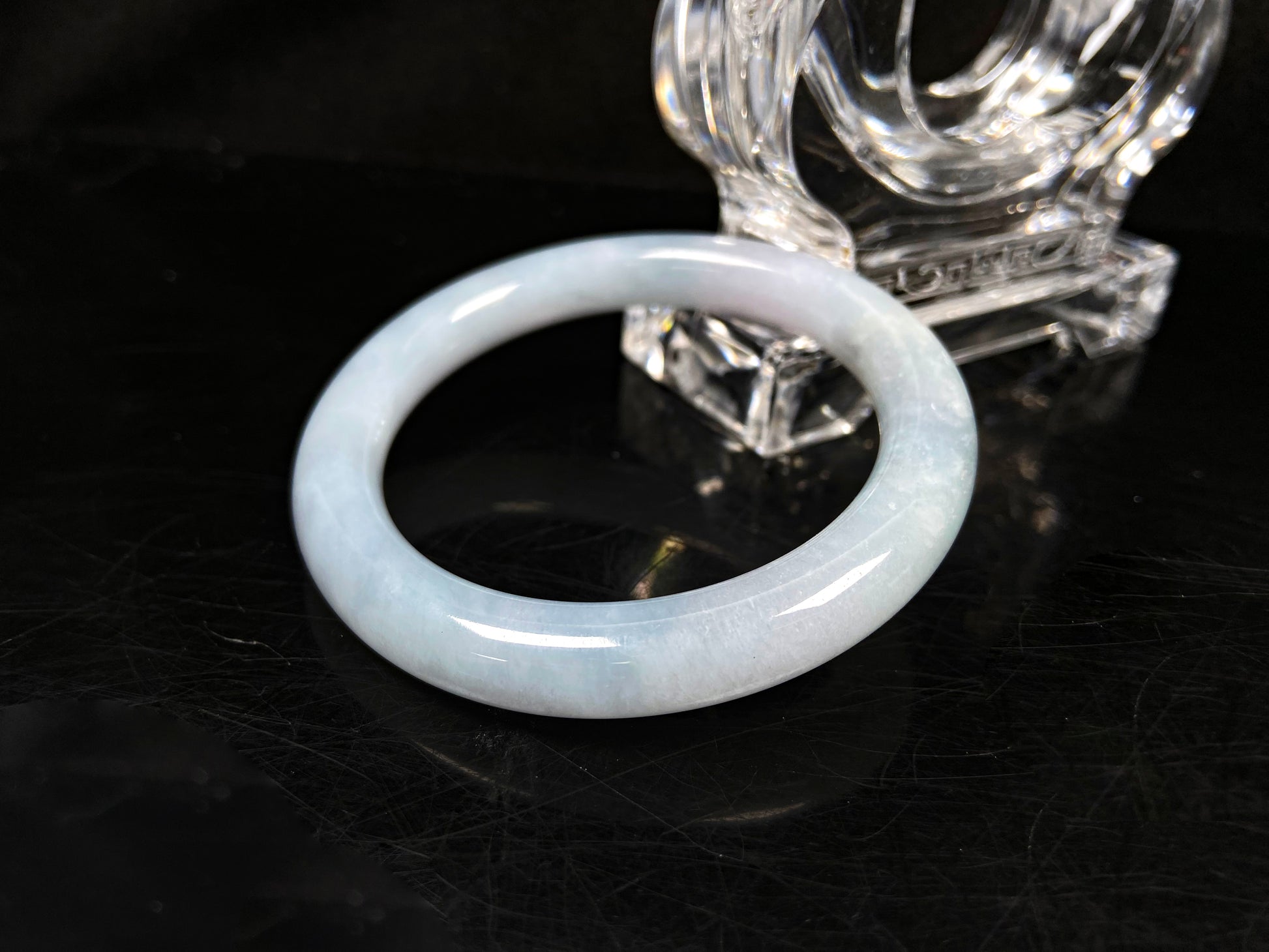 A lunar white blue green jadeite bangle.