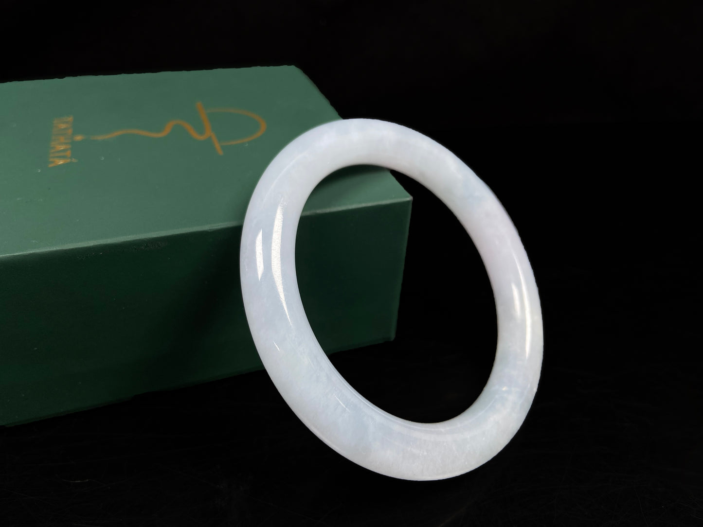 A lunar white blue green jadeite bangle.