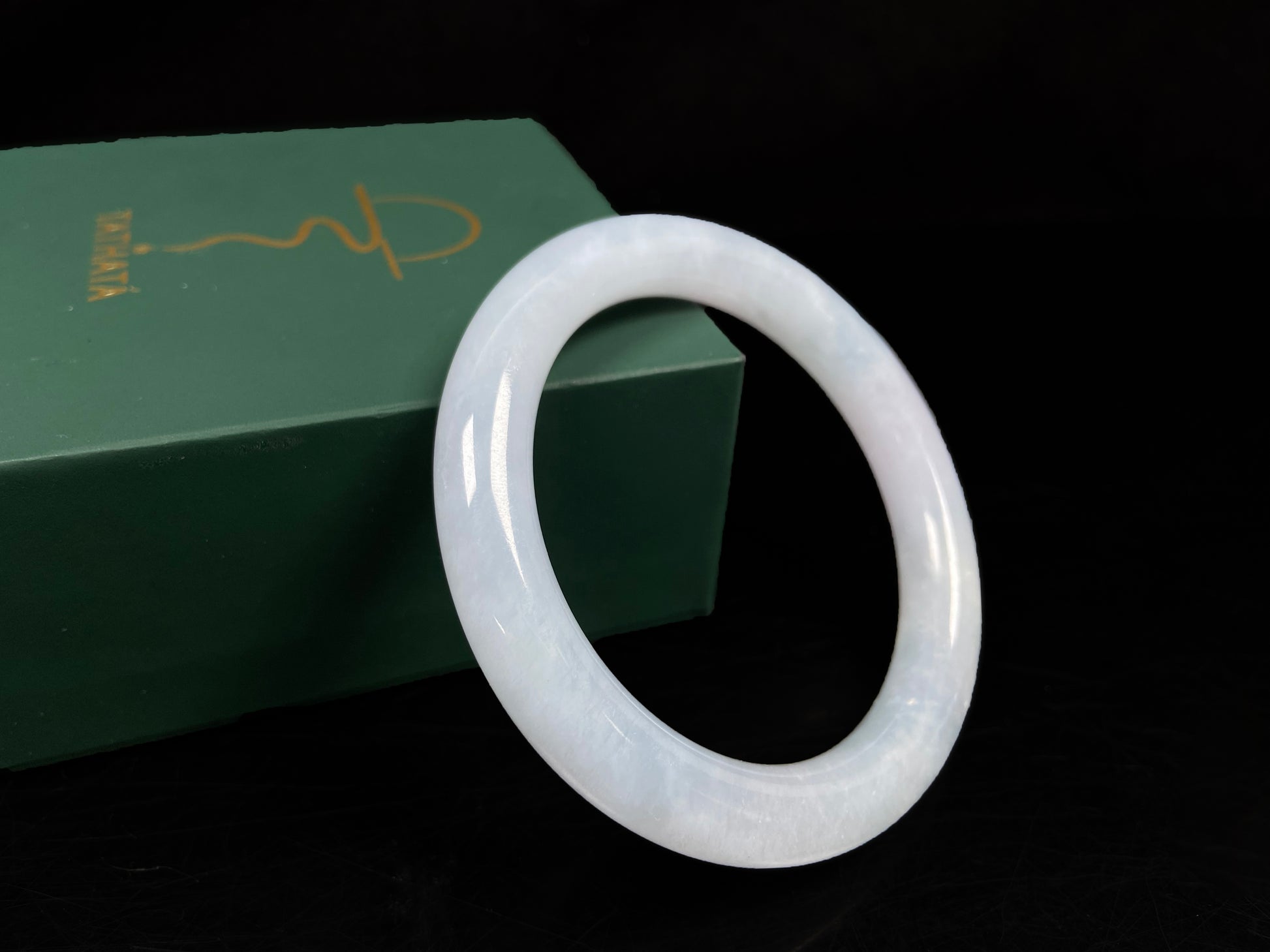 A lunar white blue green jadeite bangle.