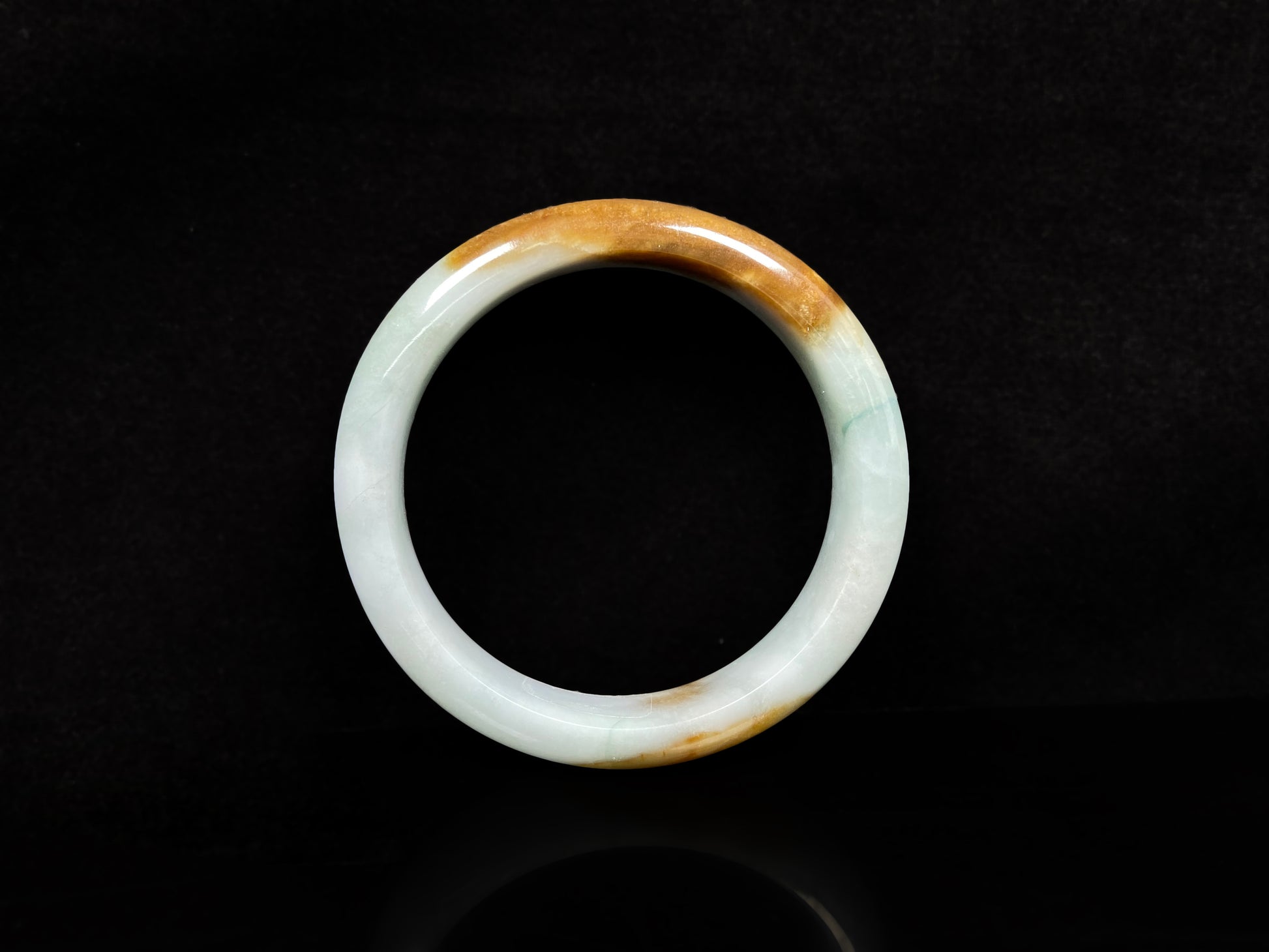 A sunset caramel jadeite bangle.