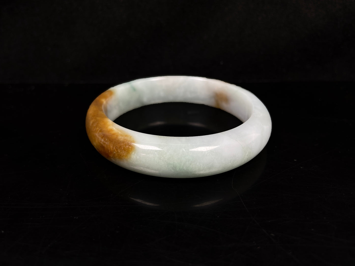 A sunset caramel jadeite bangle.
