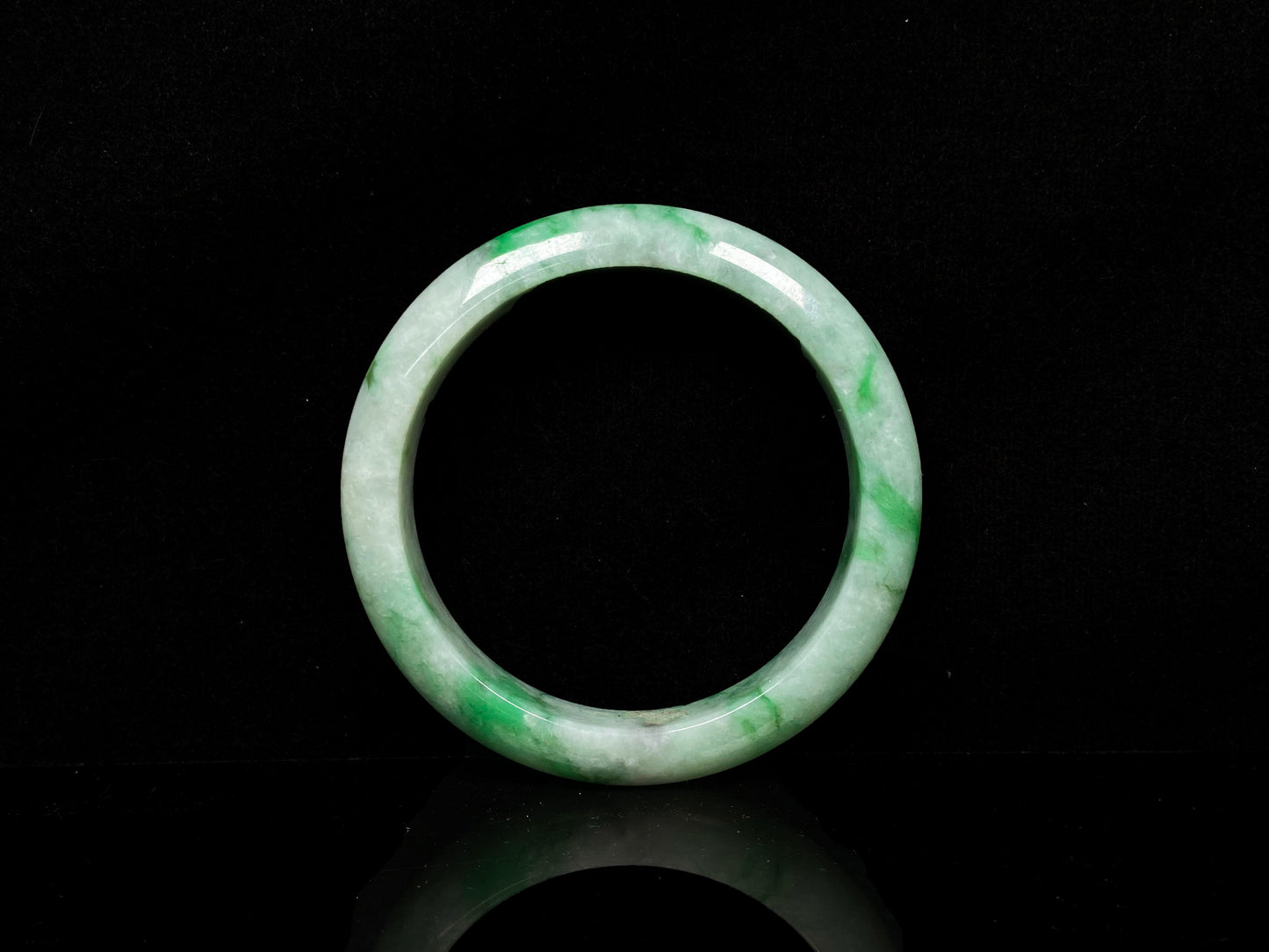 A misty bamboo green jadeite bangle.