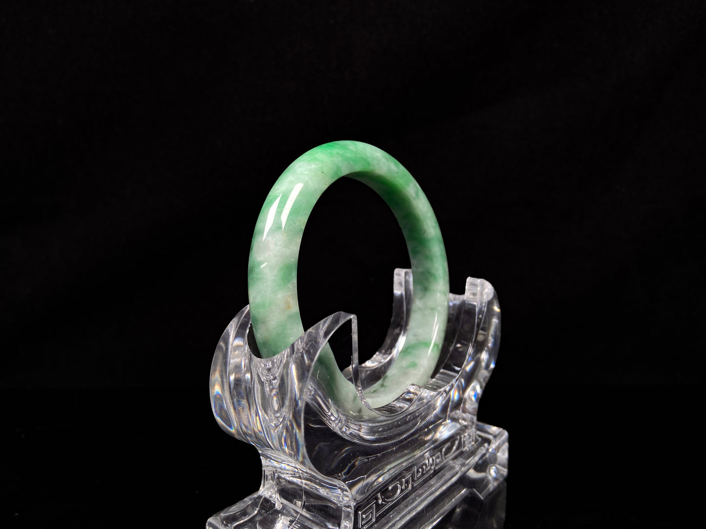 A green white jadeite bangle.