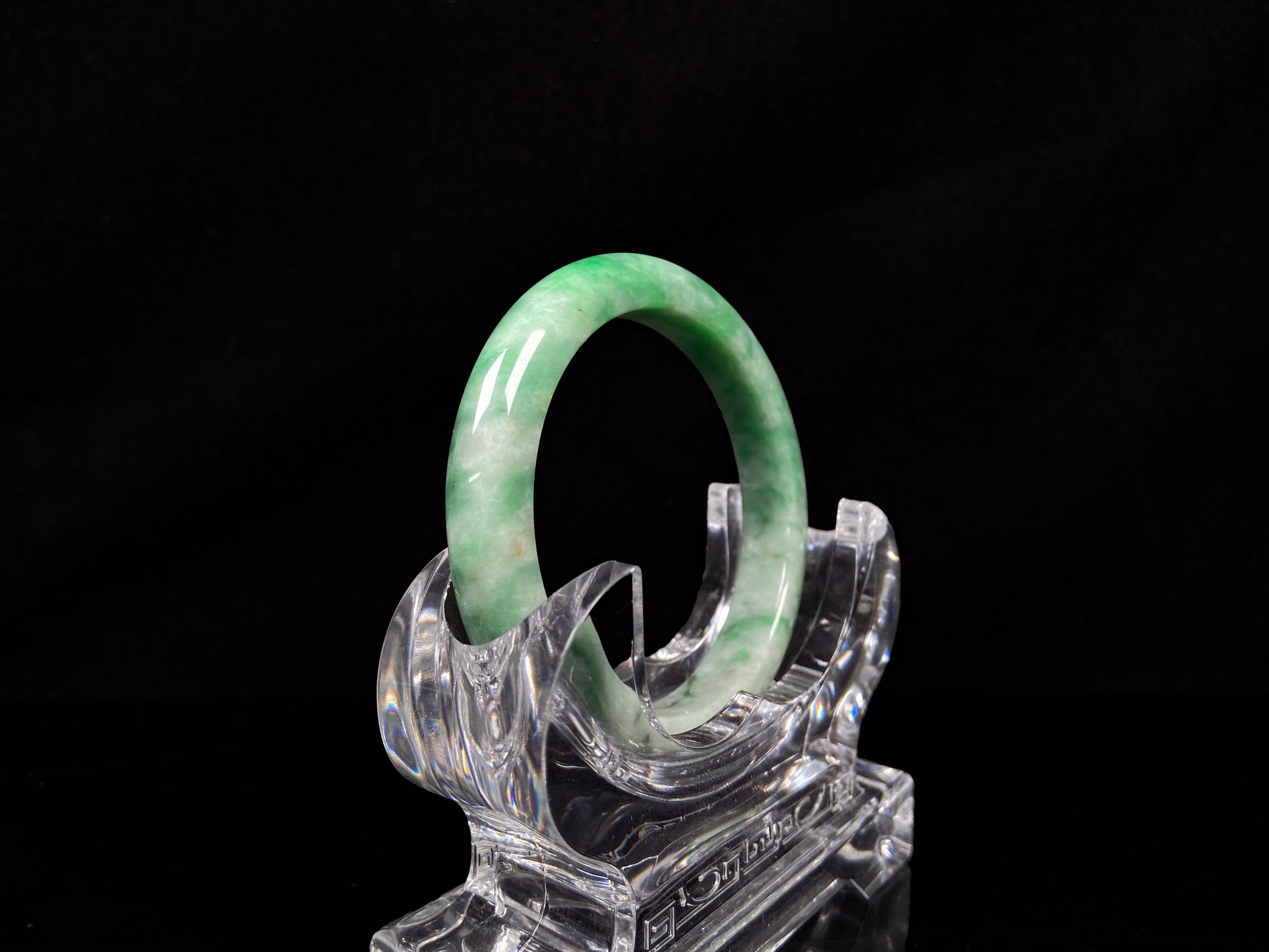A green white jadeite bangle.