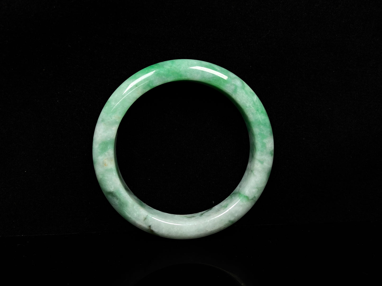 A green white jadeite bangle.