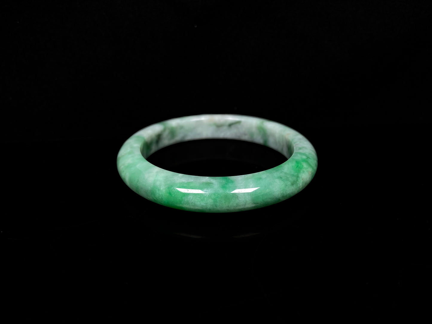 A green white jadeite bangle.