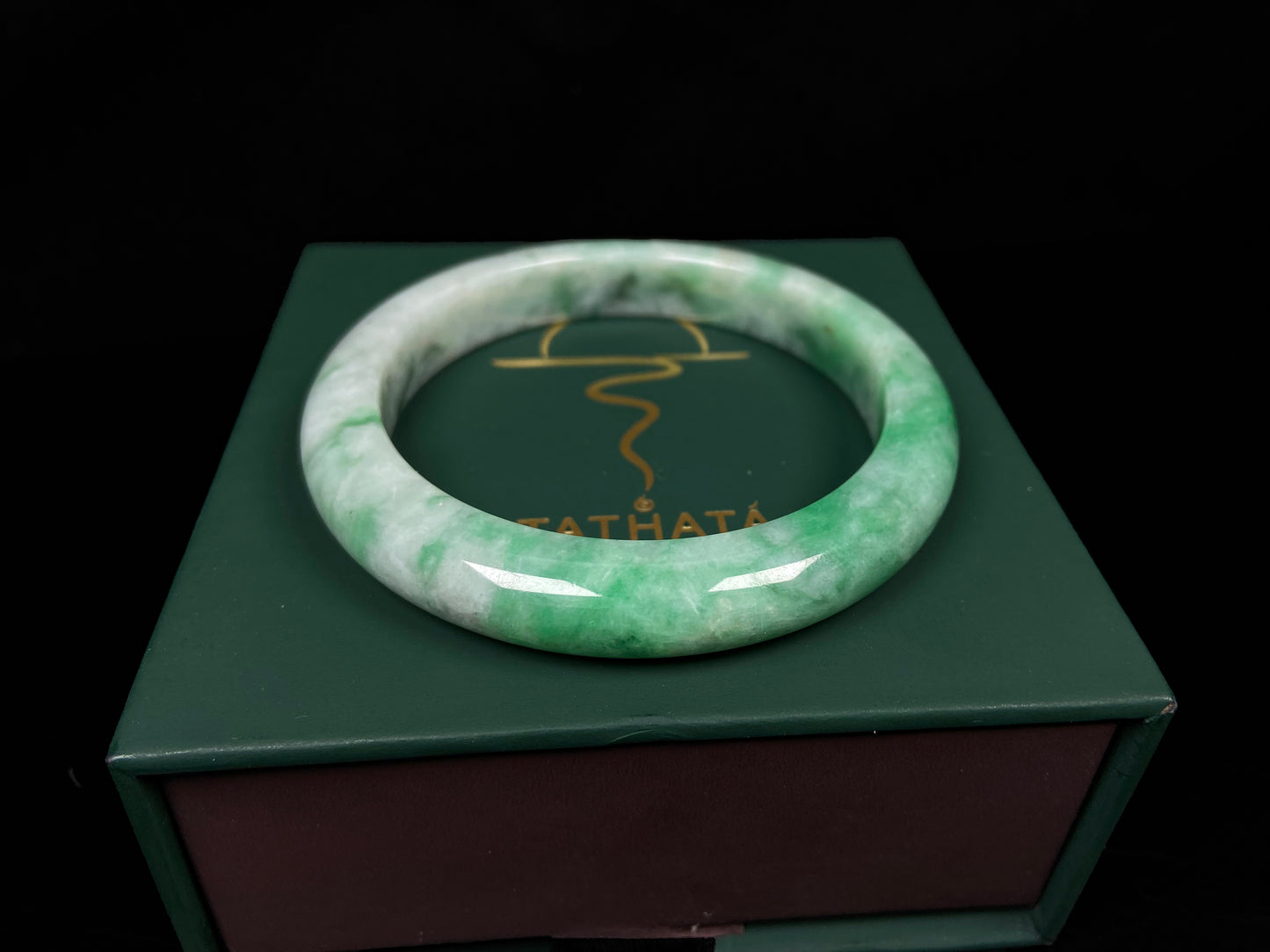 A green white jadeite bangle.
