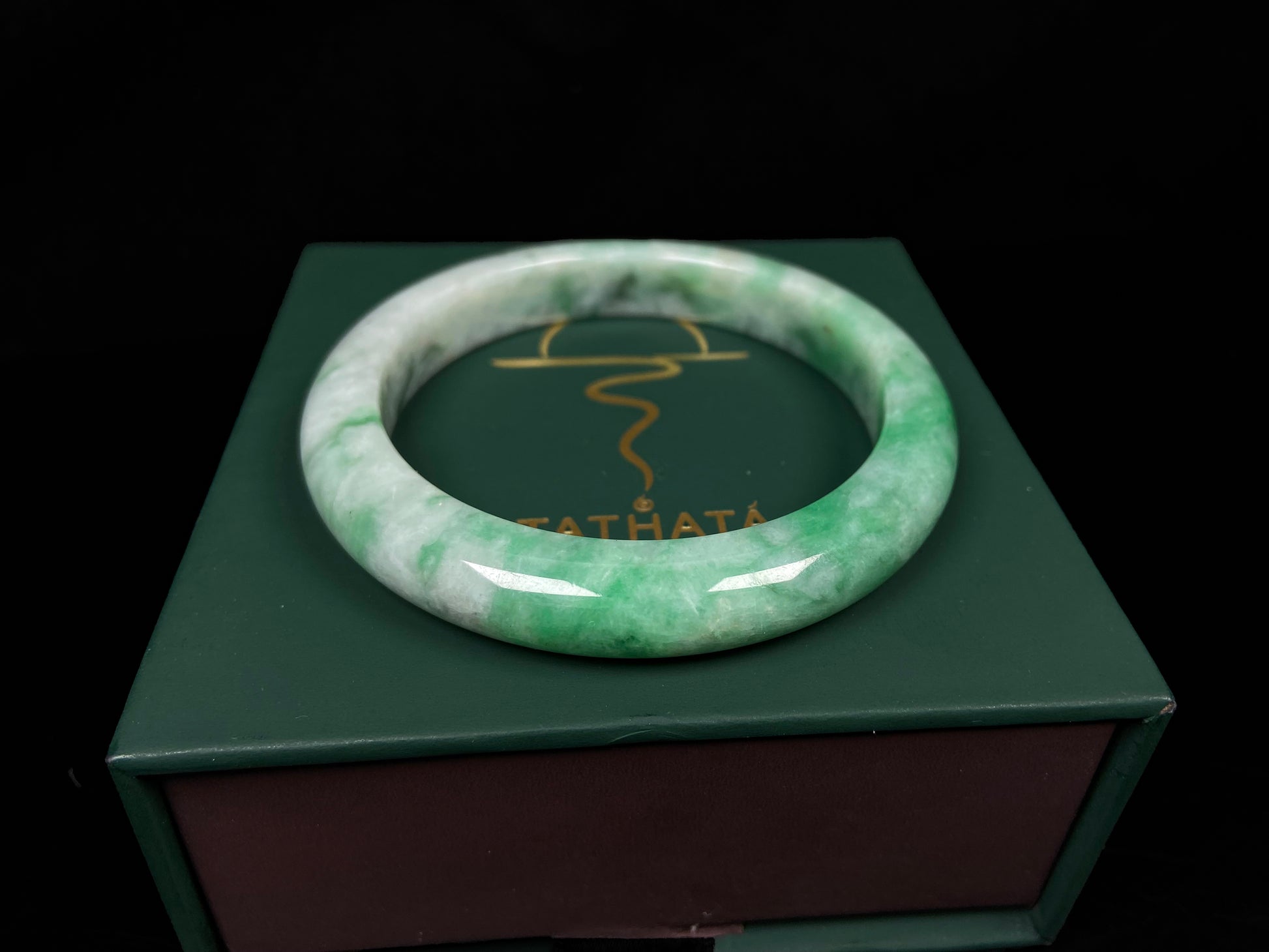 A green white jadeite bangle.
