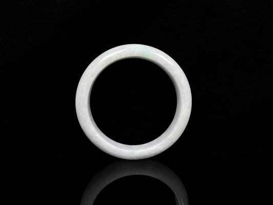 A cloudy white with pale green streaks jadeite bangle.