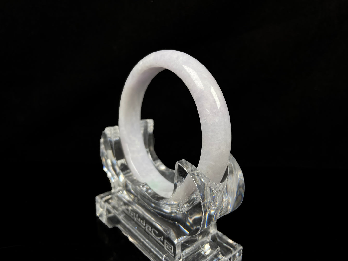 A cloudy white with pale green streaks jadeite bangle.