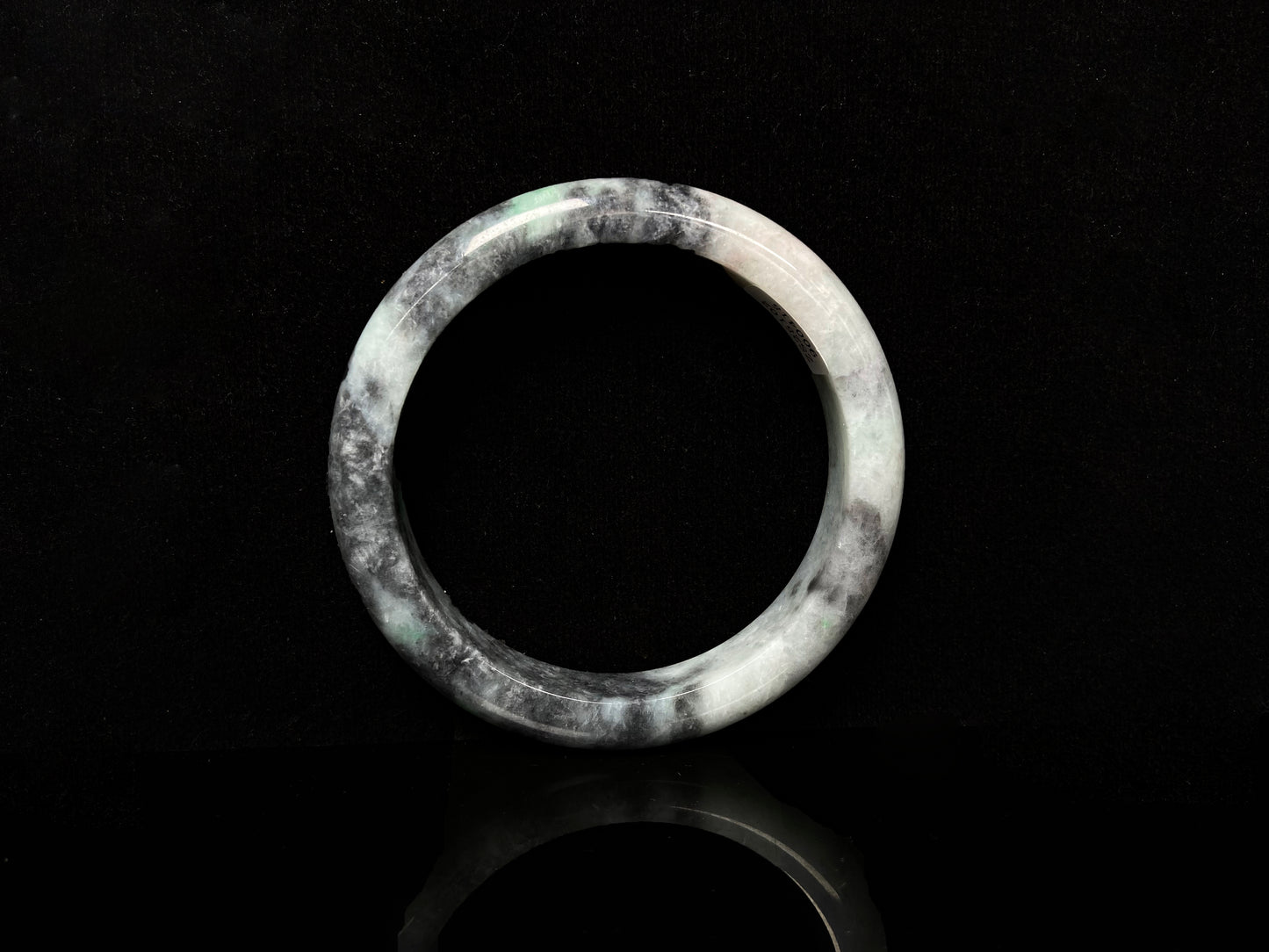 A white black jadeite bangle.