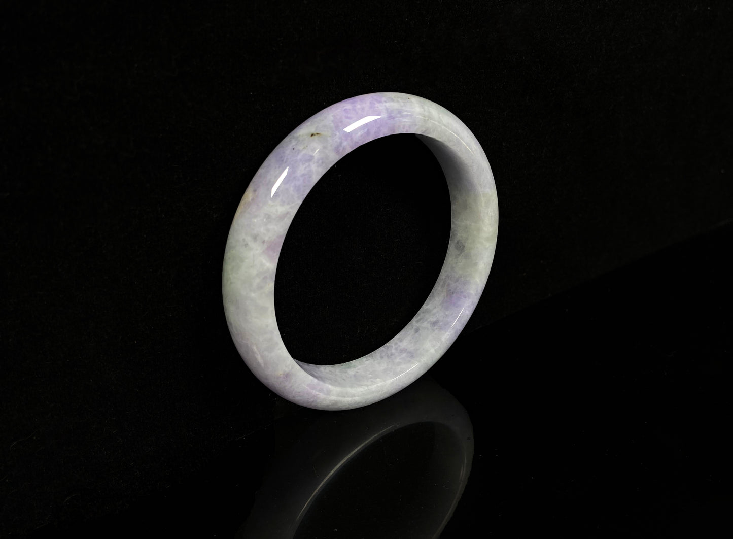 A milky green white base with soft lavender veins jadeite bangle.