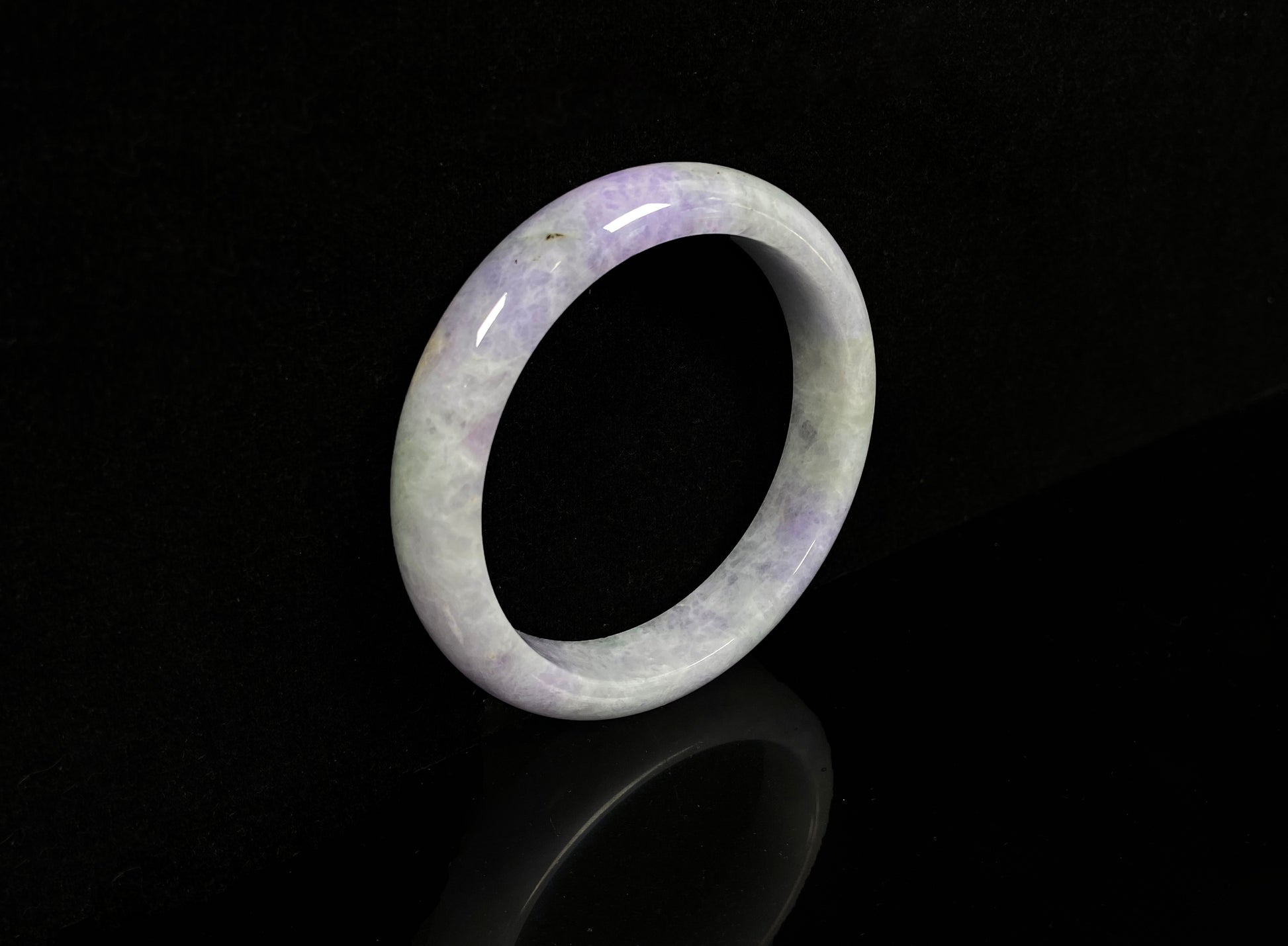 A milky green white base with soft lavender veins jadeite bangle.