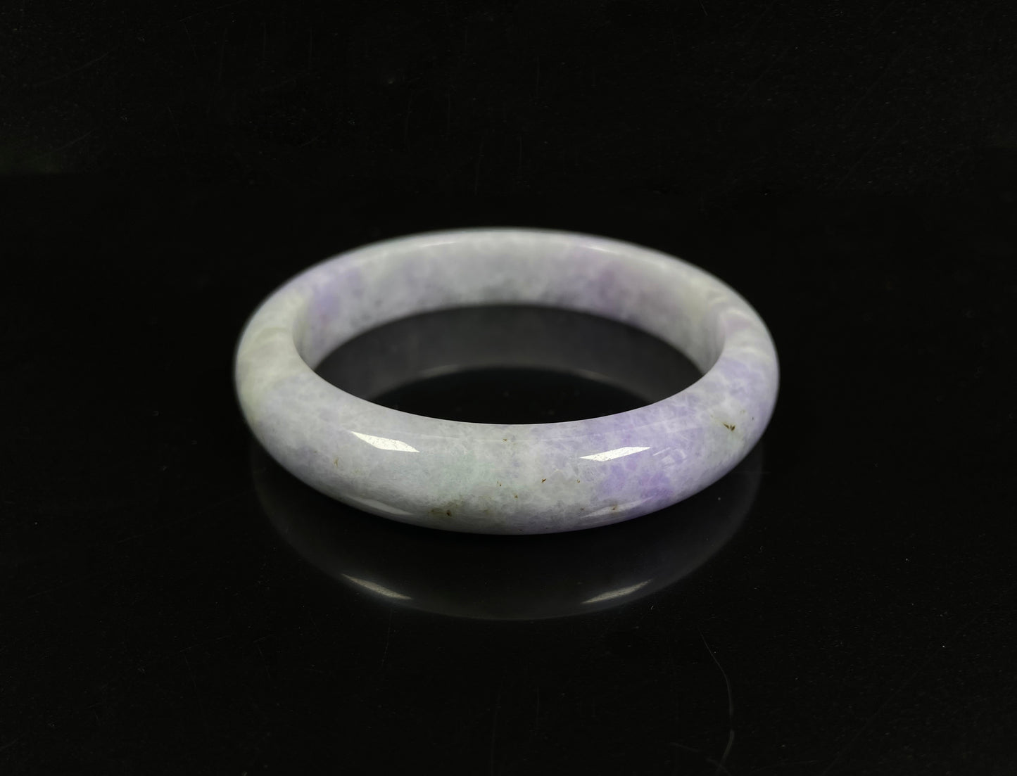 A milky green white base with soft lavender veins jadeite bangle.