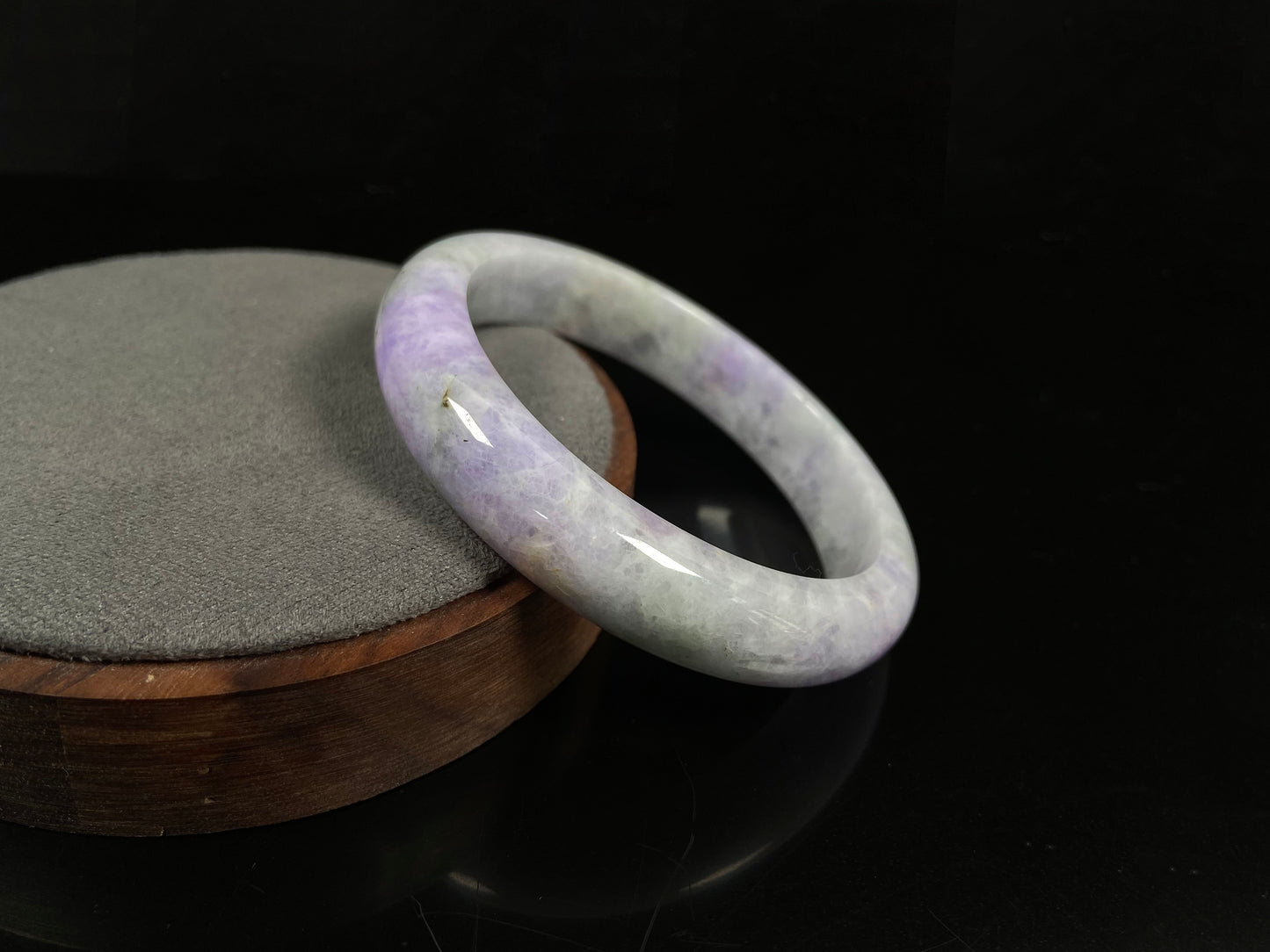 A milky green white base with soft lavender veins jadeite bangle.