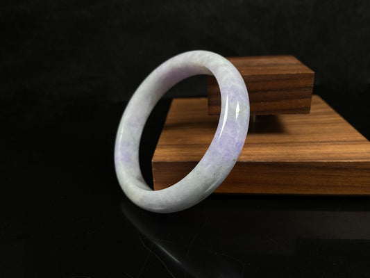 A milky green white base with soft lavender veins jadeite bangle.