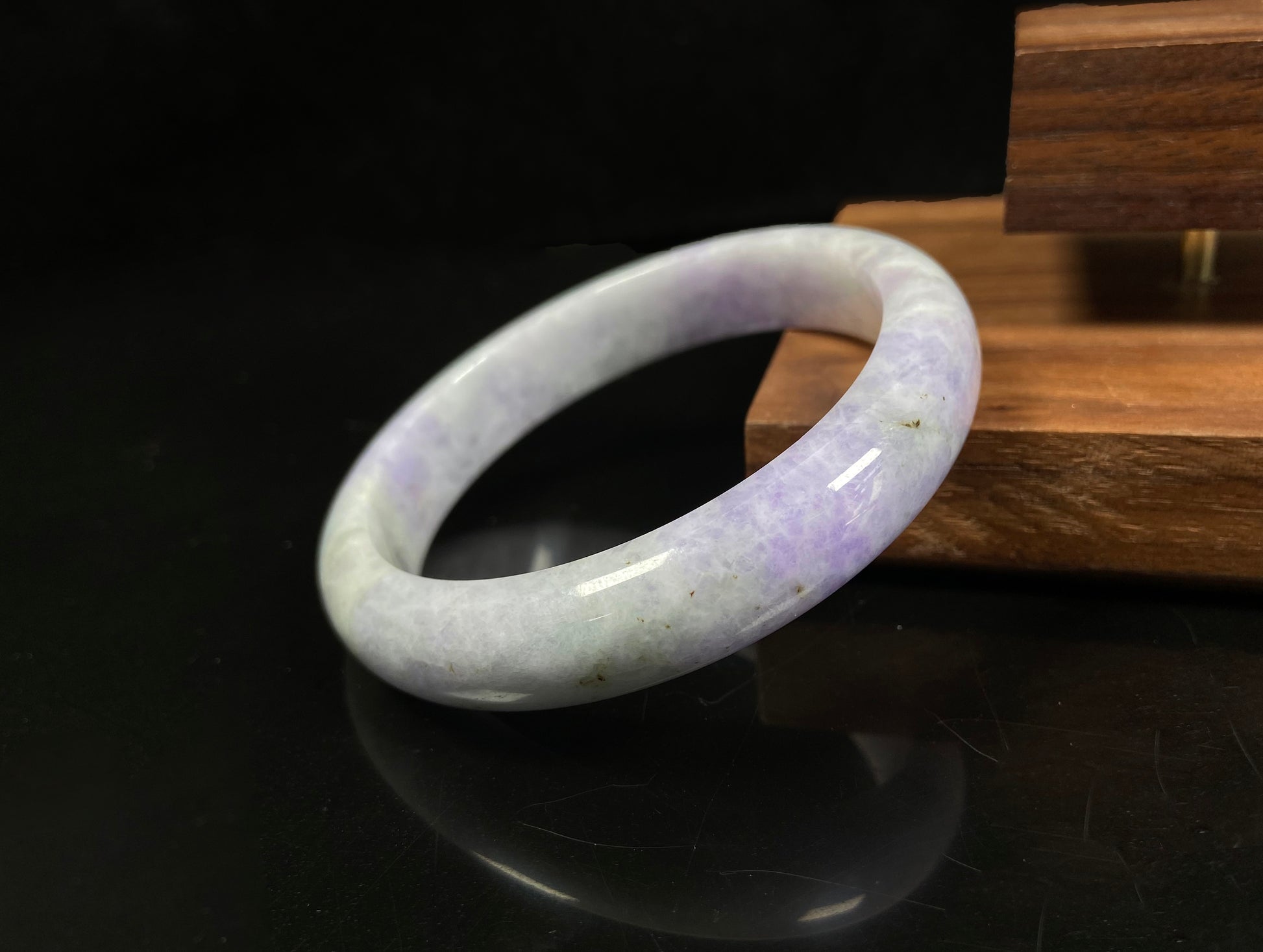 A milky green white base with soft lavender veins jadeite bangle.