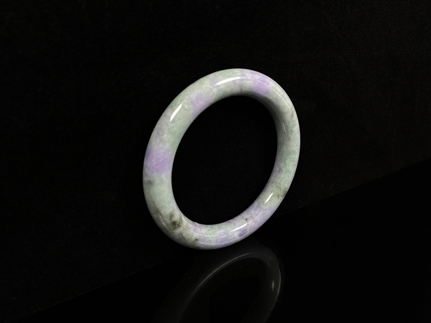 A intermingled green and lavender purple jadeite bangle.
