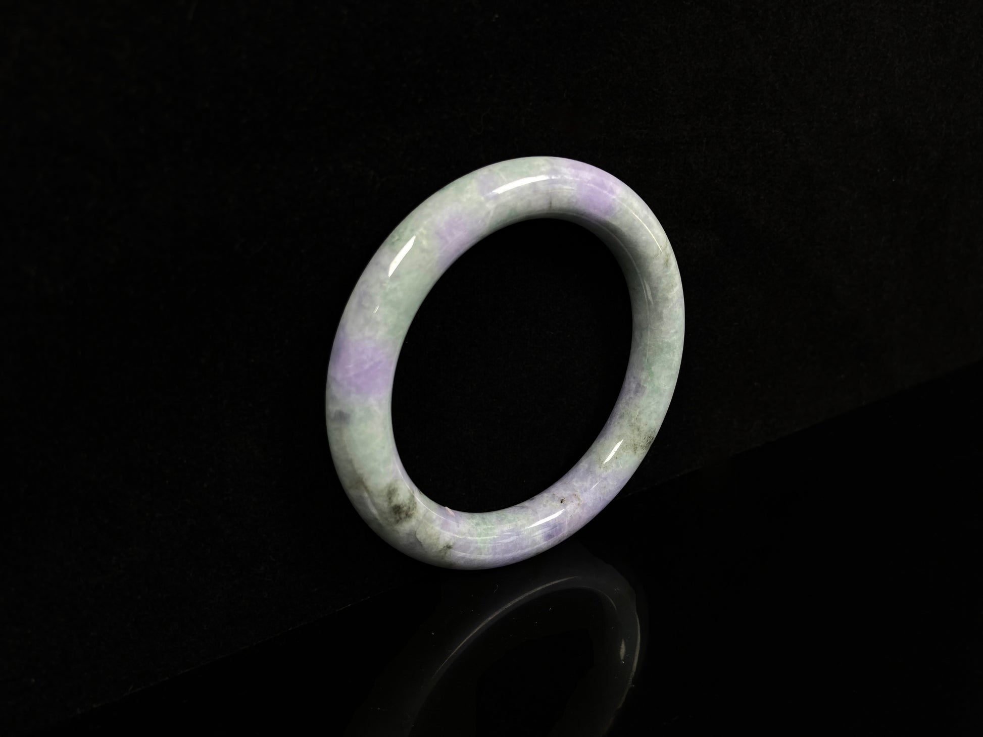 A intermingled green and lavender purple jadeite bangle.