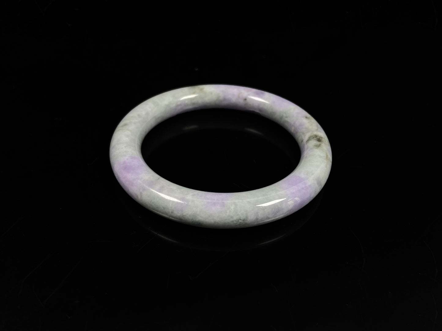 A intermingled green and lavender purple jadeite bangle.