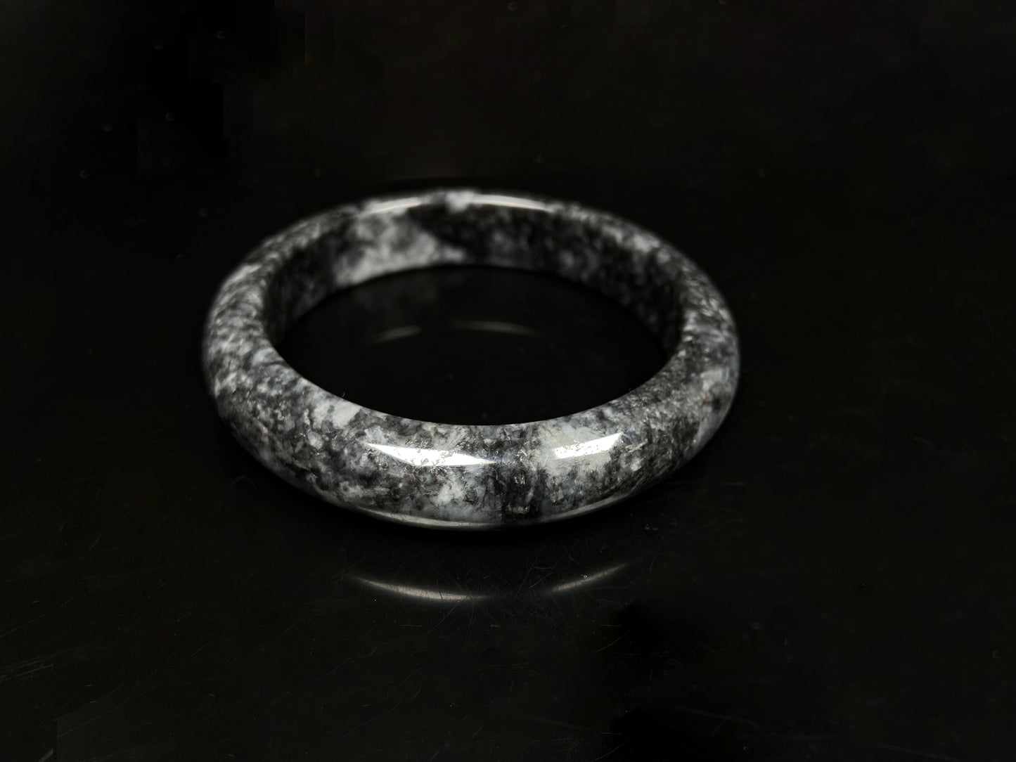 A white black jadeite bangle.
