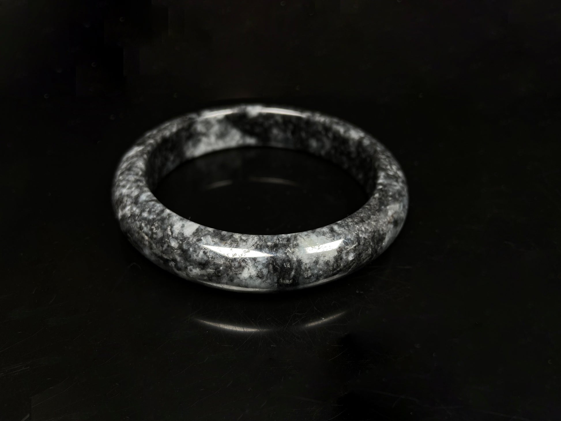 A white black jadeite bangle.