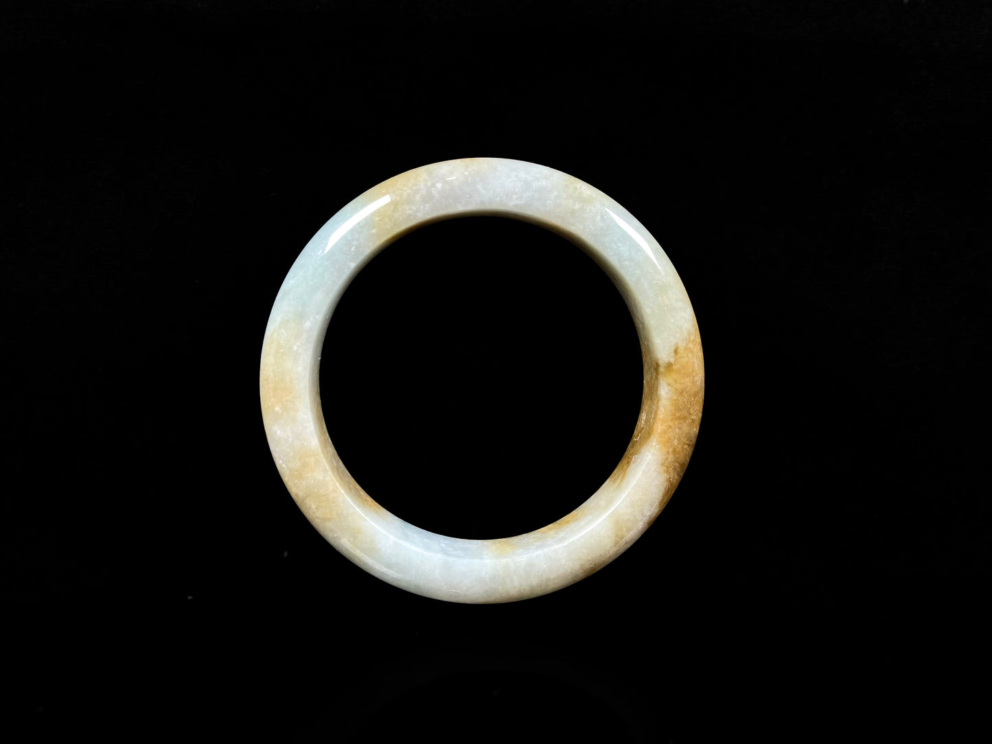 A honeyed amber veil jadeite bangle.