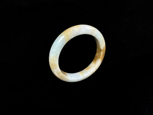 A honeyed amber veil jadeite bangle.