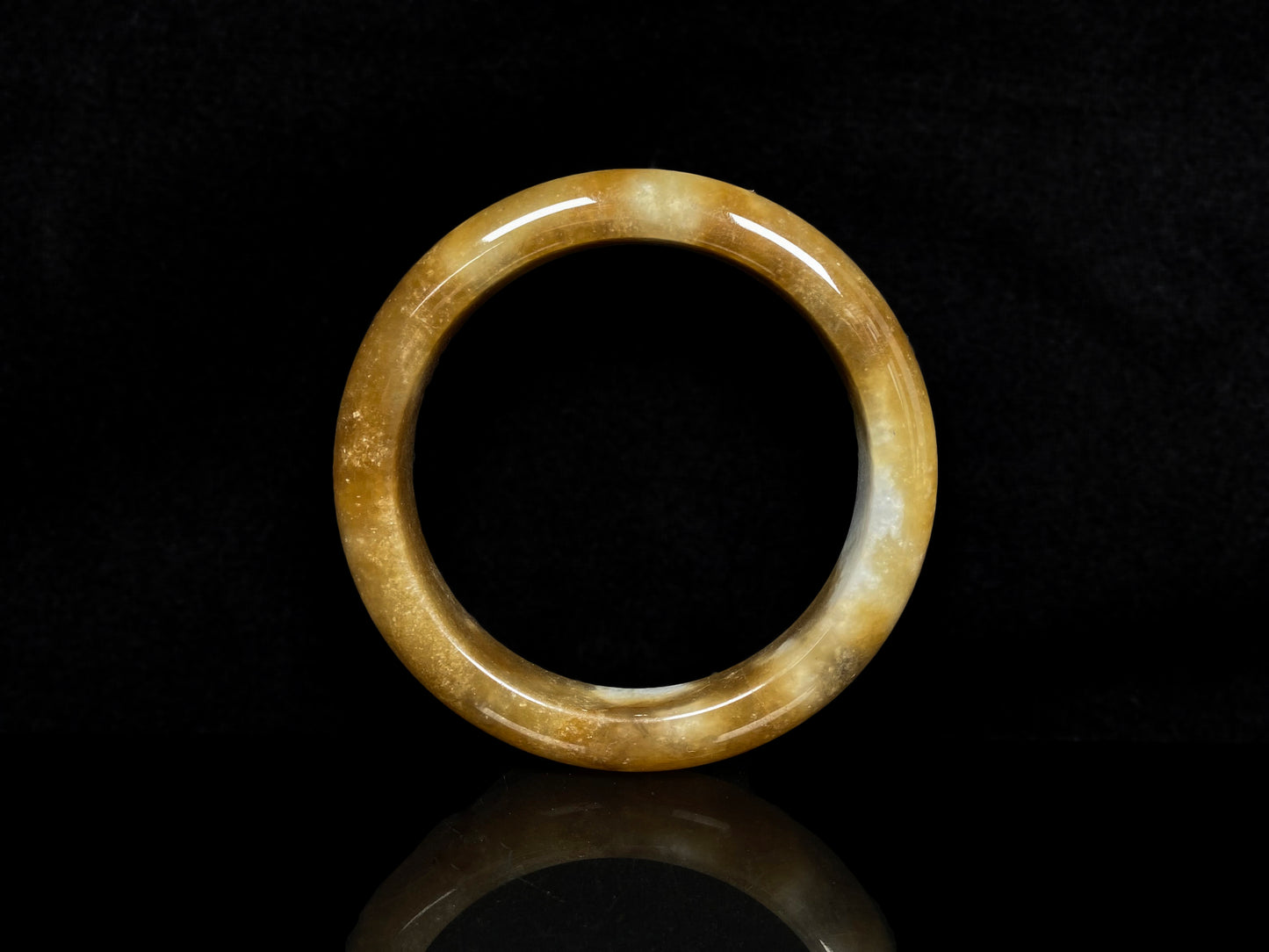 A ambered wisp luster jadeite bangle.