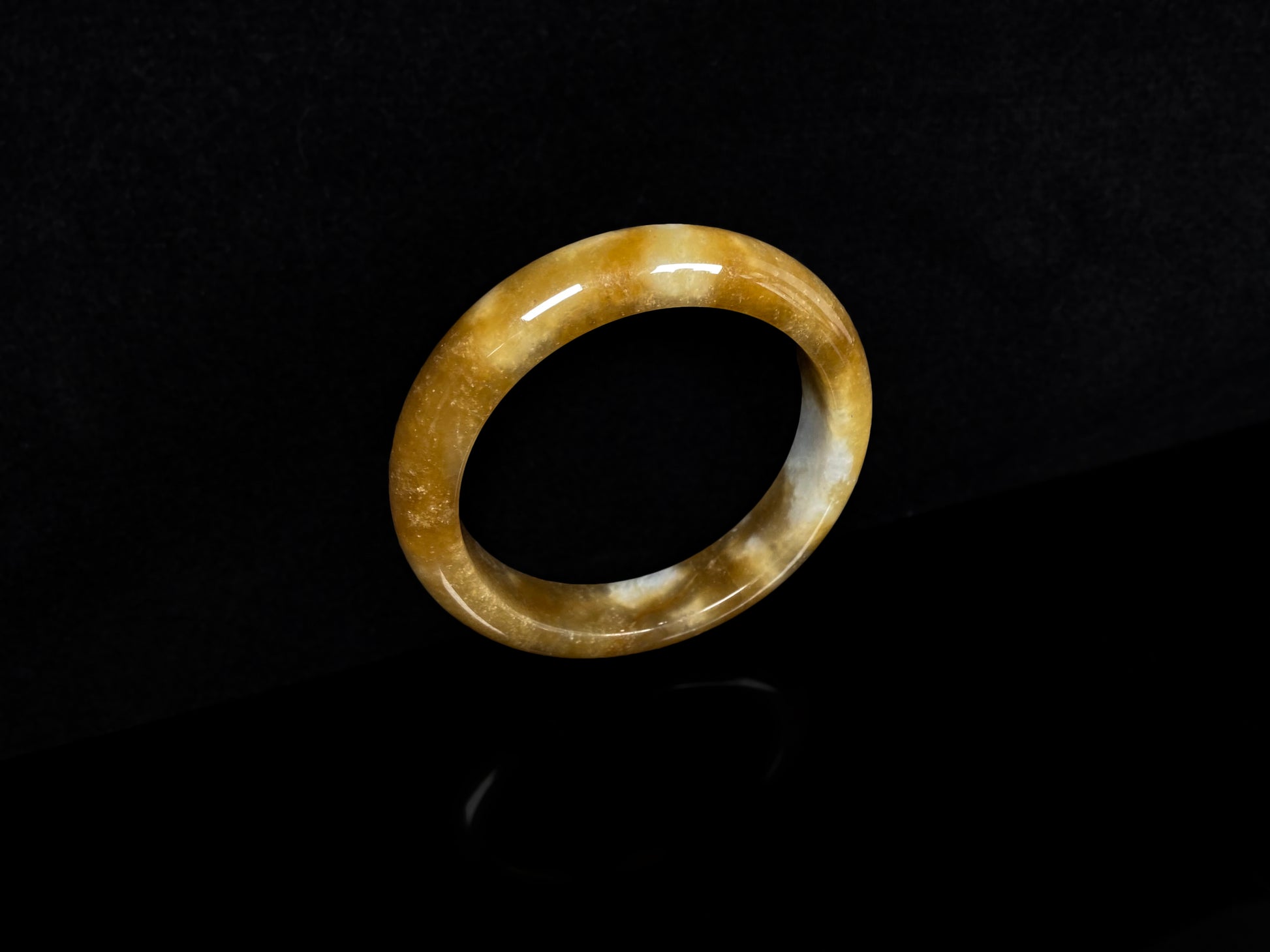 A ambered wisp luster jadeite bangle.