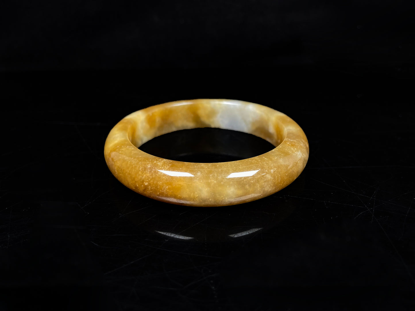 A ambered wisp luster jadeite bangle.