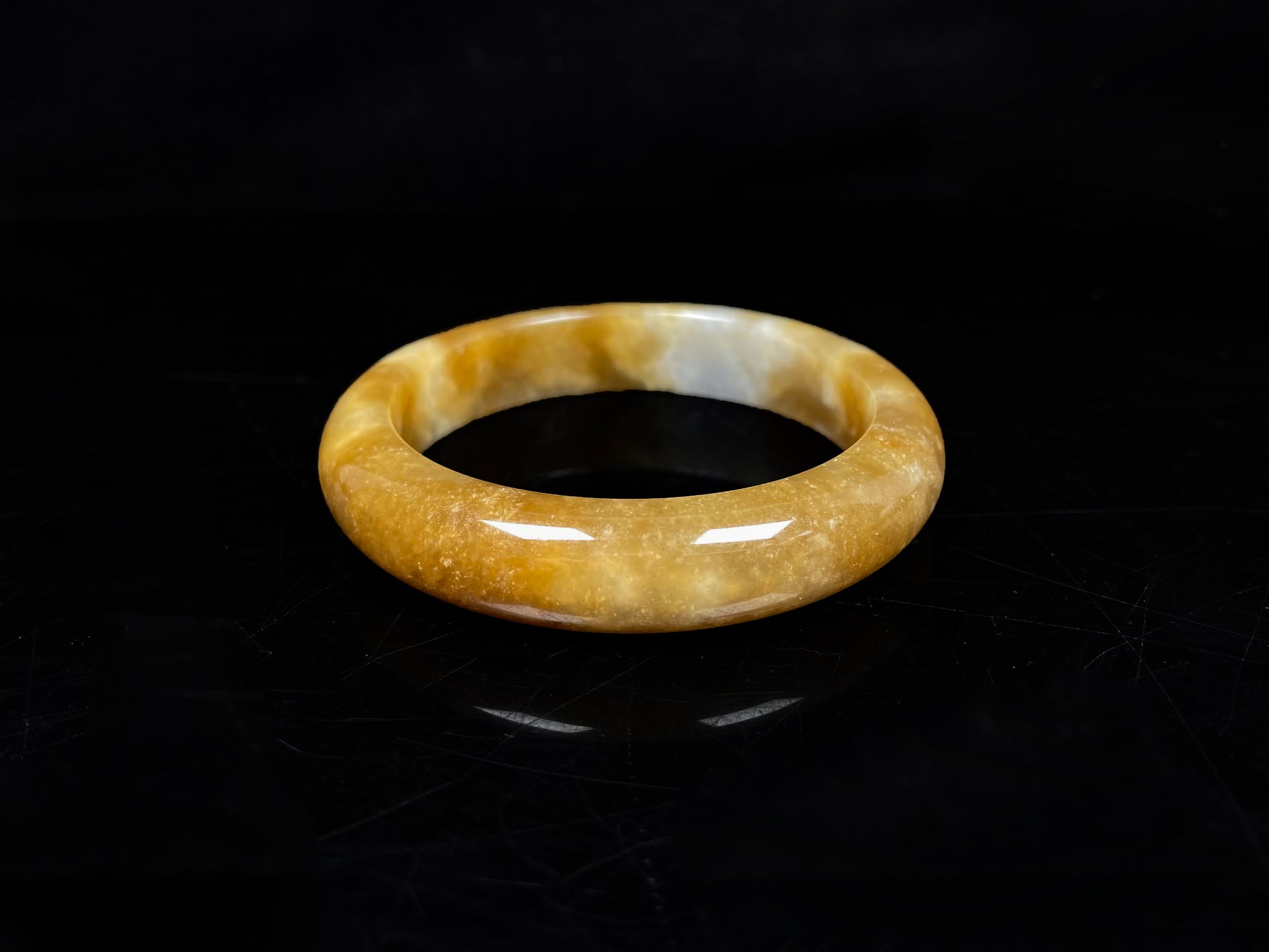 A ambered wisp luster jadeite bangle.