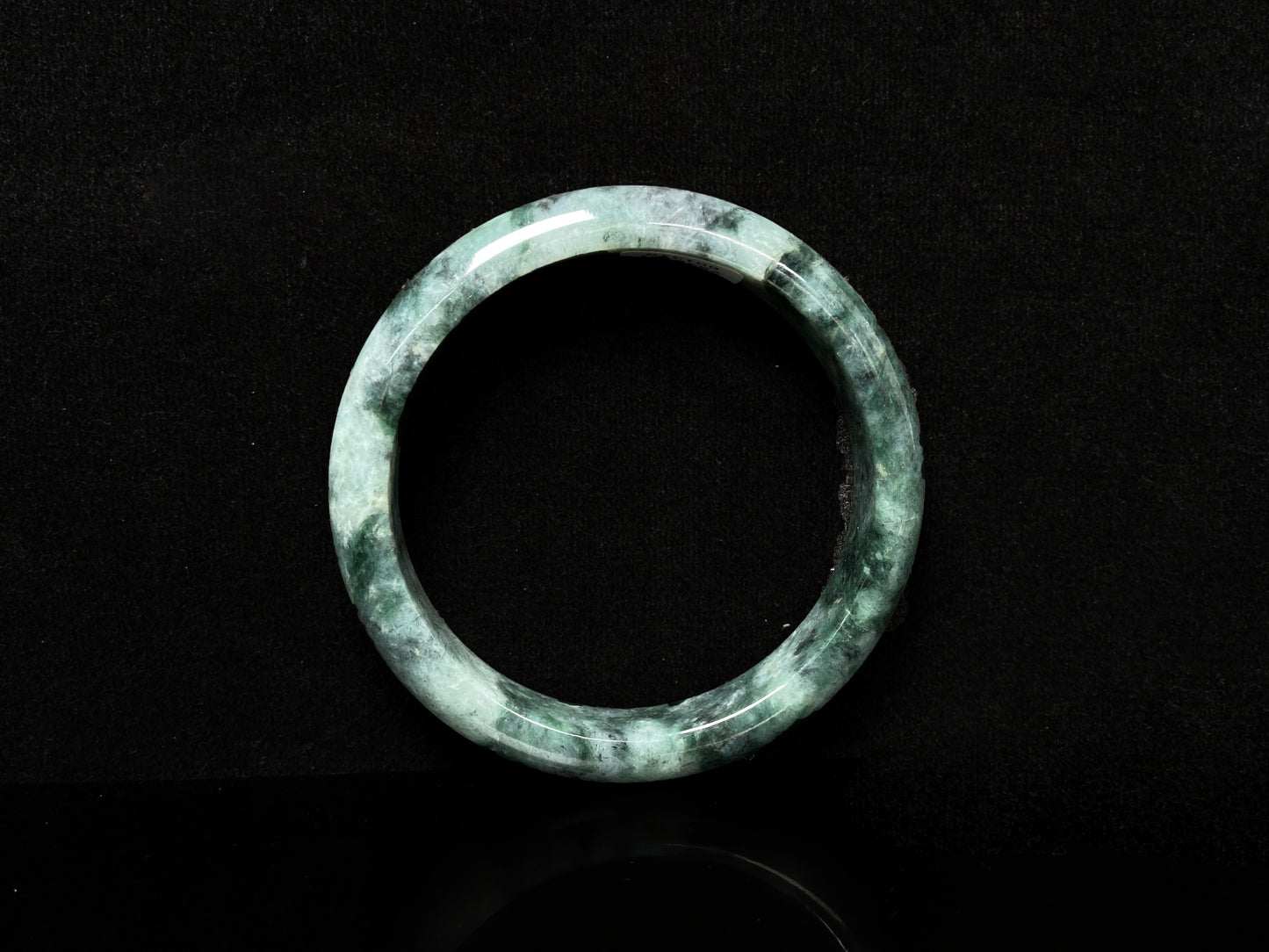 A white black jadeite bangle.