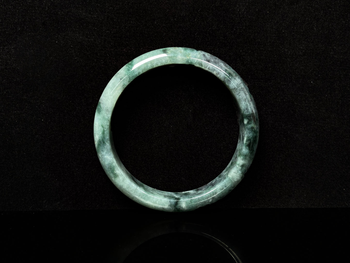 A white black jadeite bangle.