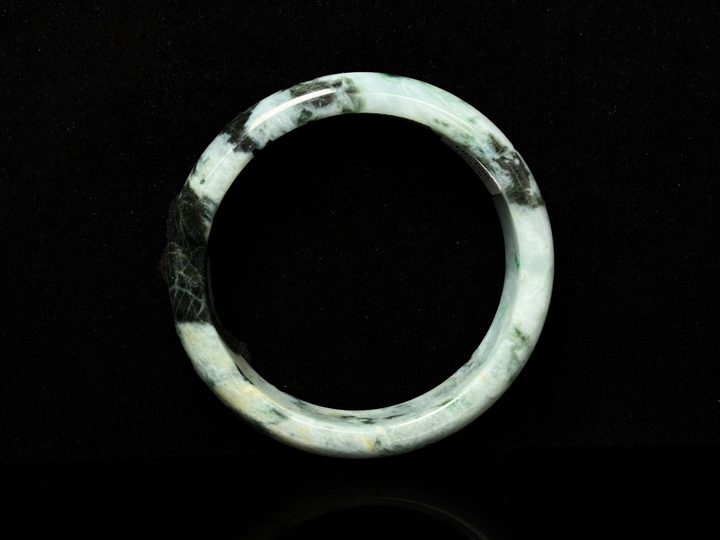 A white black jadeite bangle.