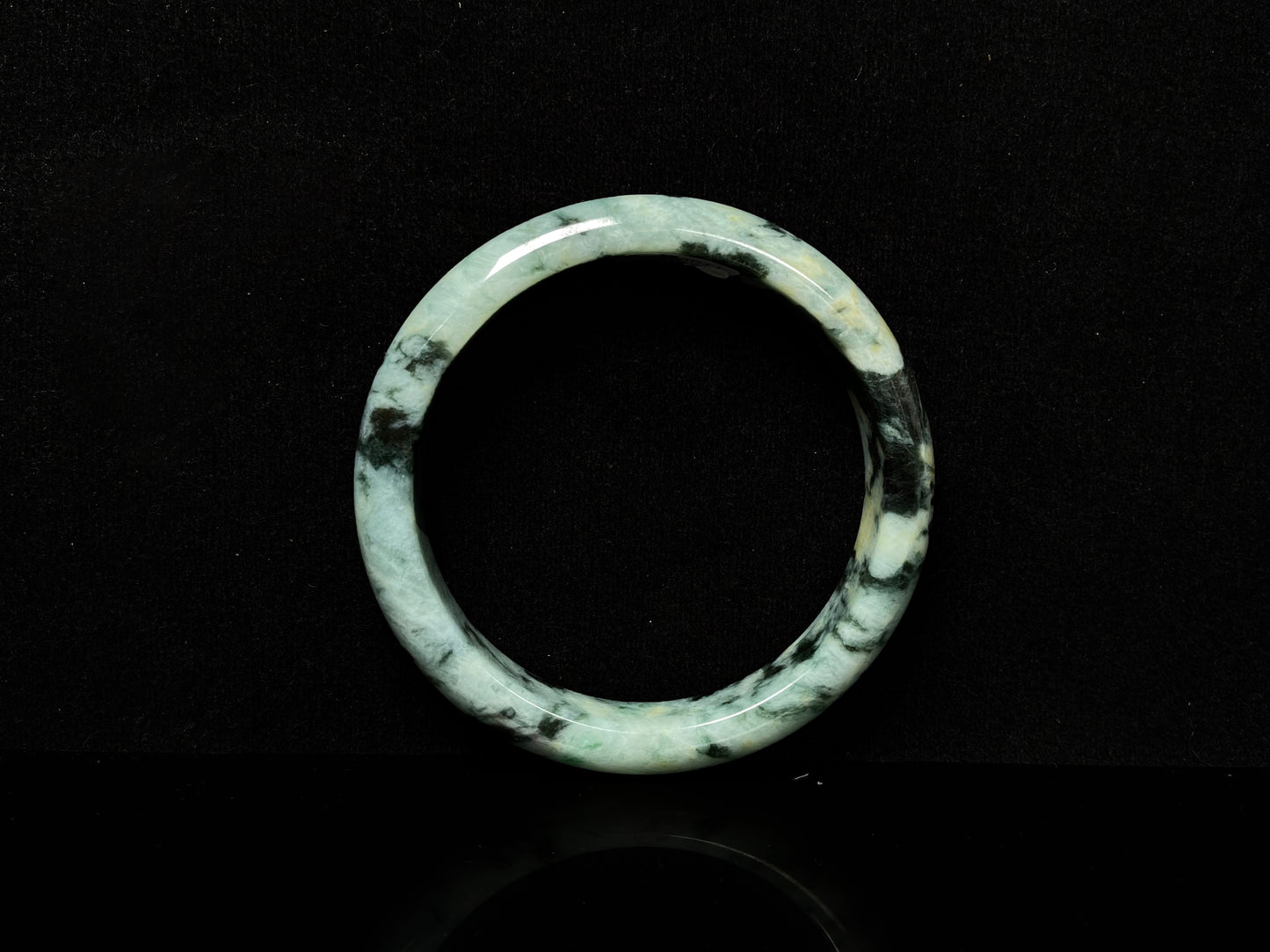 A white black jadeite bangle.